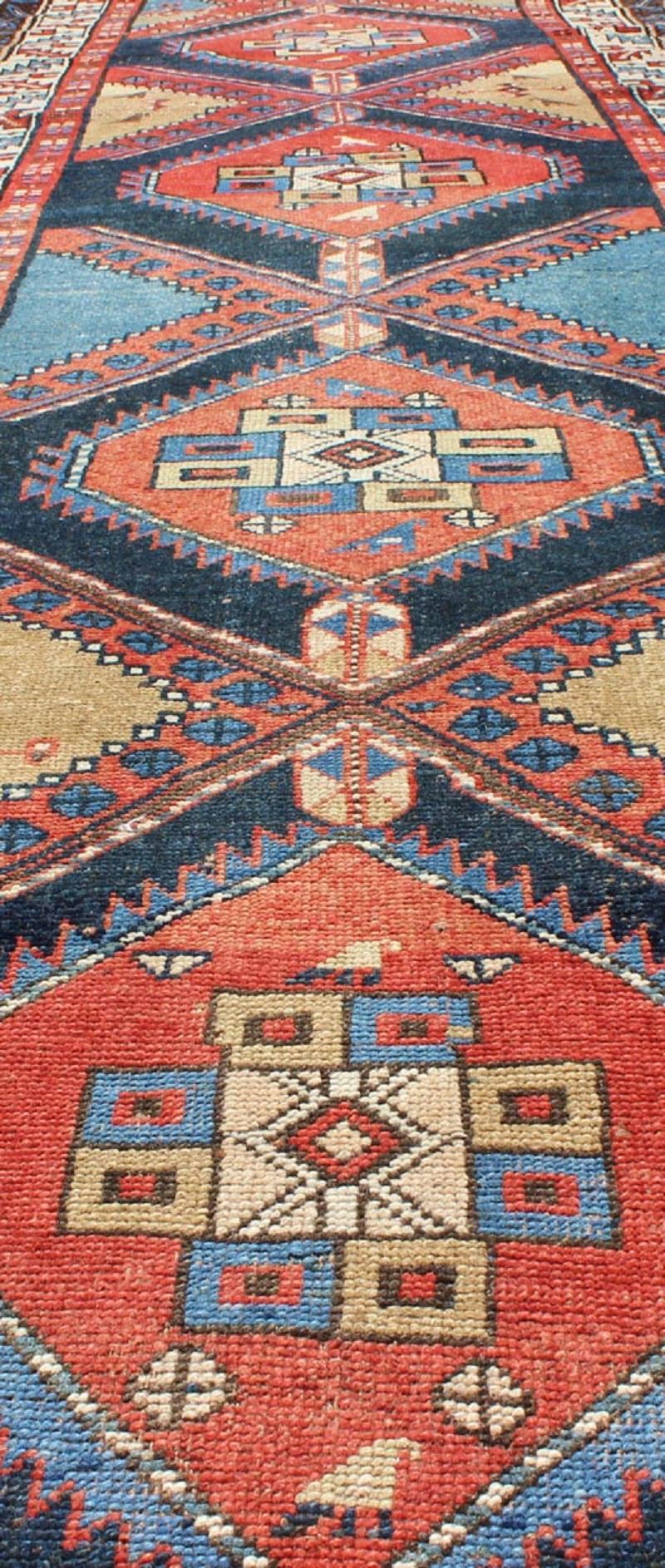 Early 20th Century Bold Medallion Design Antique Persian Heriz Runner in Red and Blue Tones For Sale