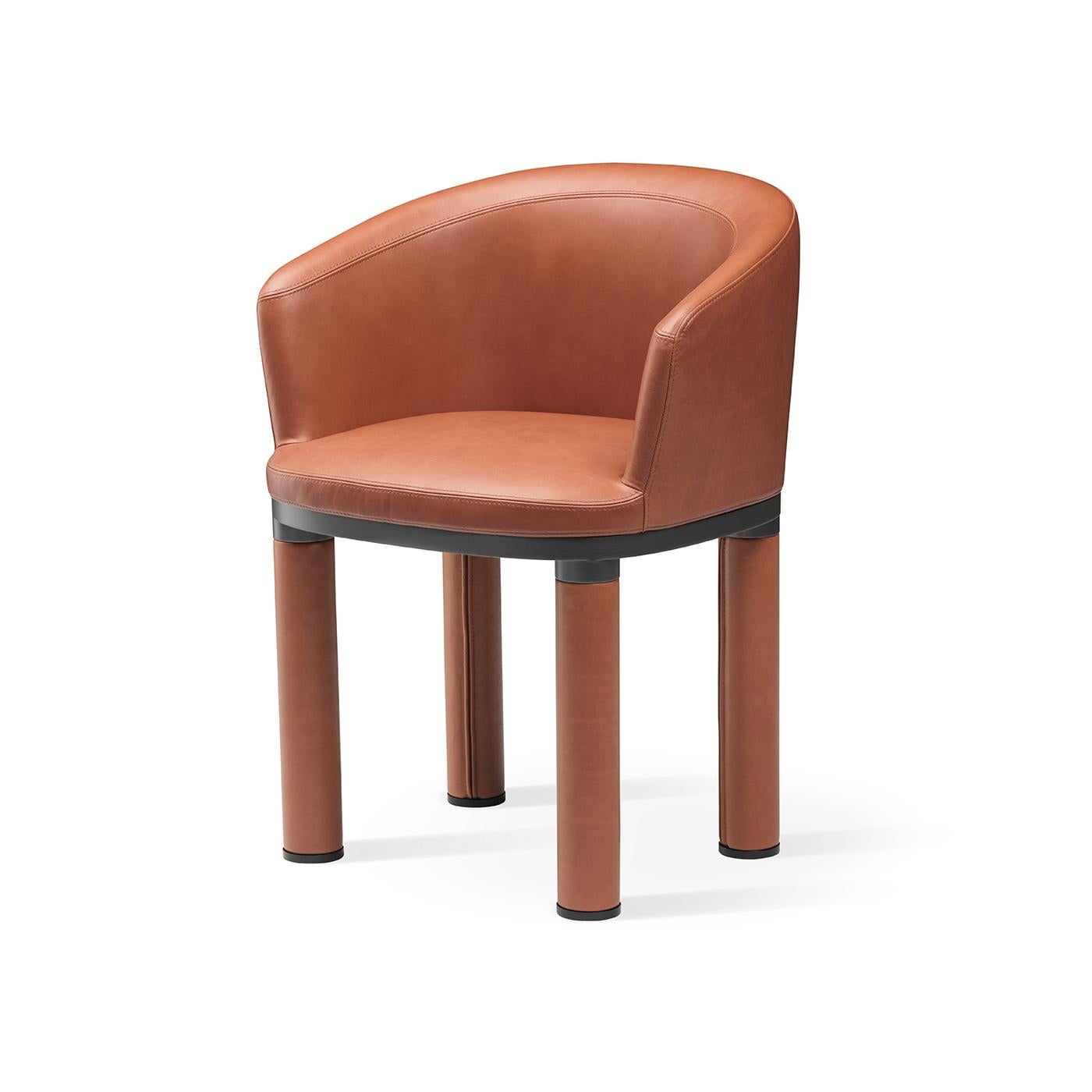 Sober and inviting, this stunning armchair flaunts a clean and essential design of minimalist style. Defined by soft and curved lines, it rests on a brass structure upholstered on the legs and on the welcoming seat with fine Napa leather showcasing