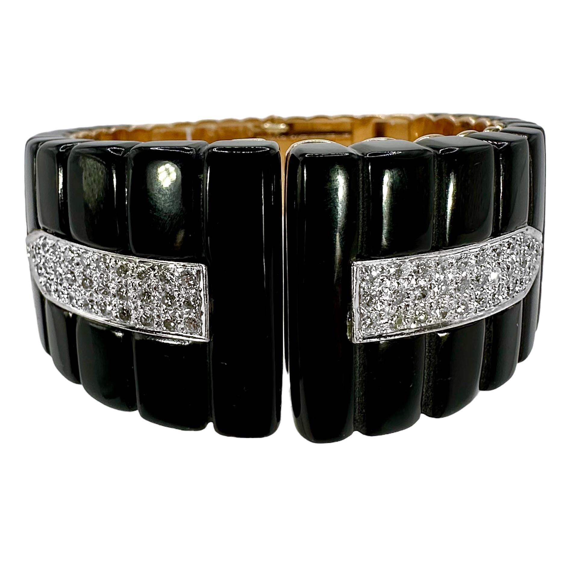 This tailored, stylish, and precision crafted 14k yellow gold, black onyx and diamond cuff bracelet embodies high fashion and quality in every respect. All gold work is done to the highest jewelry making standards. Two large black onyx panels are
