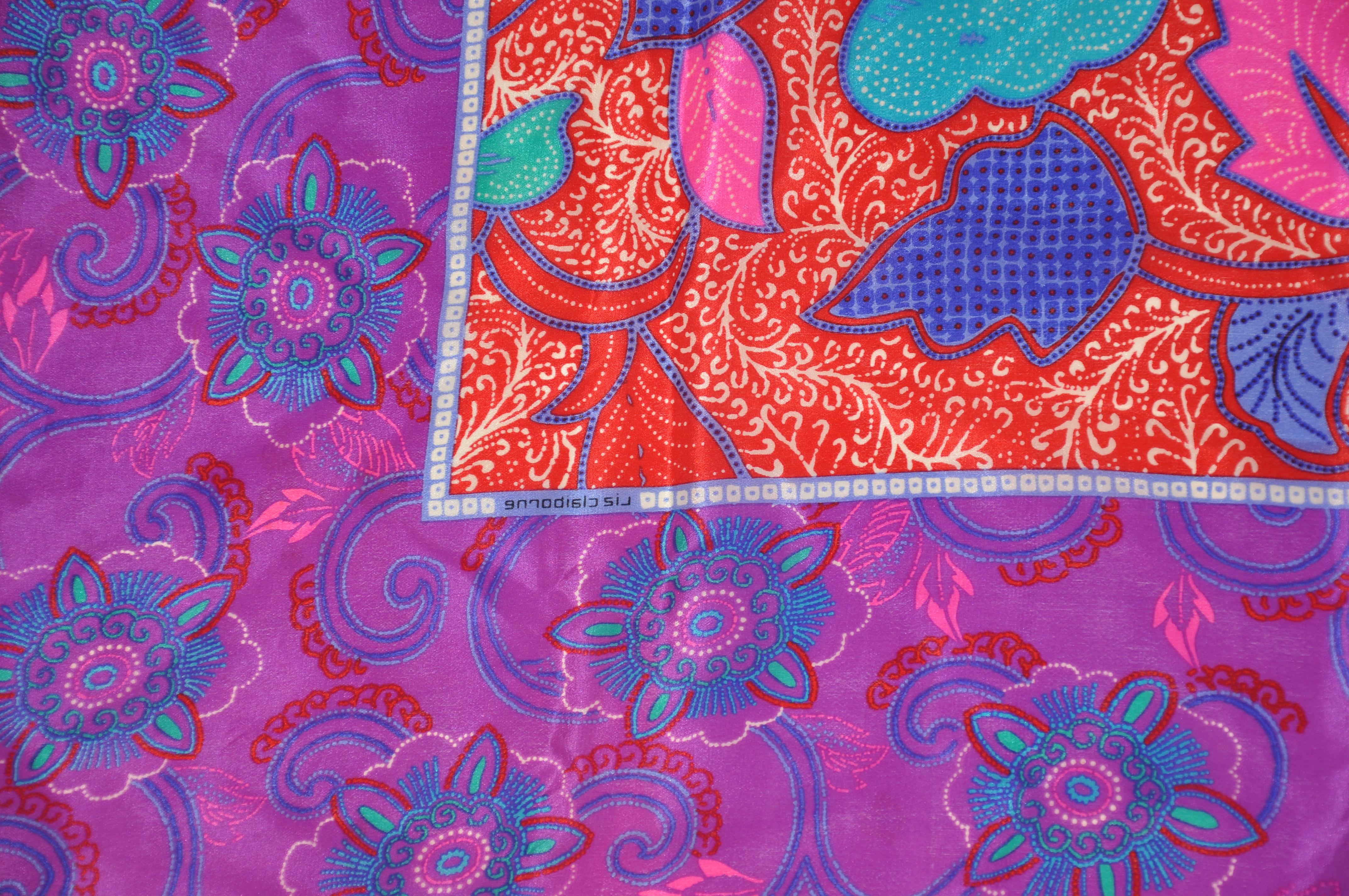       This wonderfully bold and vivid violet florals borders surrounding a garden of florals silk scarf accented with rolled edges, measures 30 inches by 31 inches. Made in Italy.