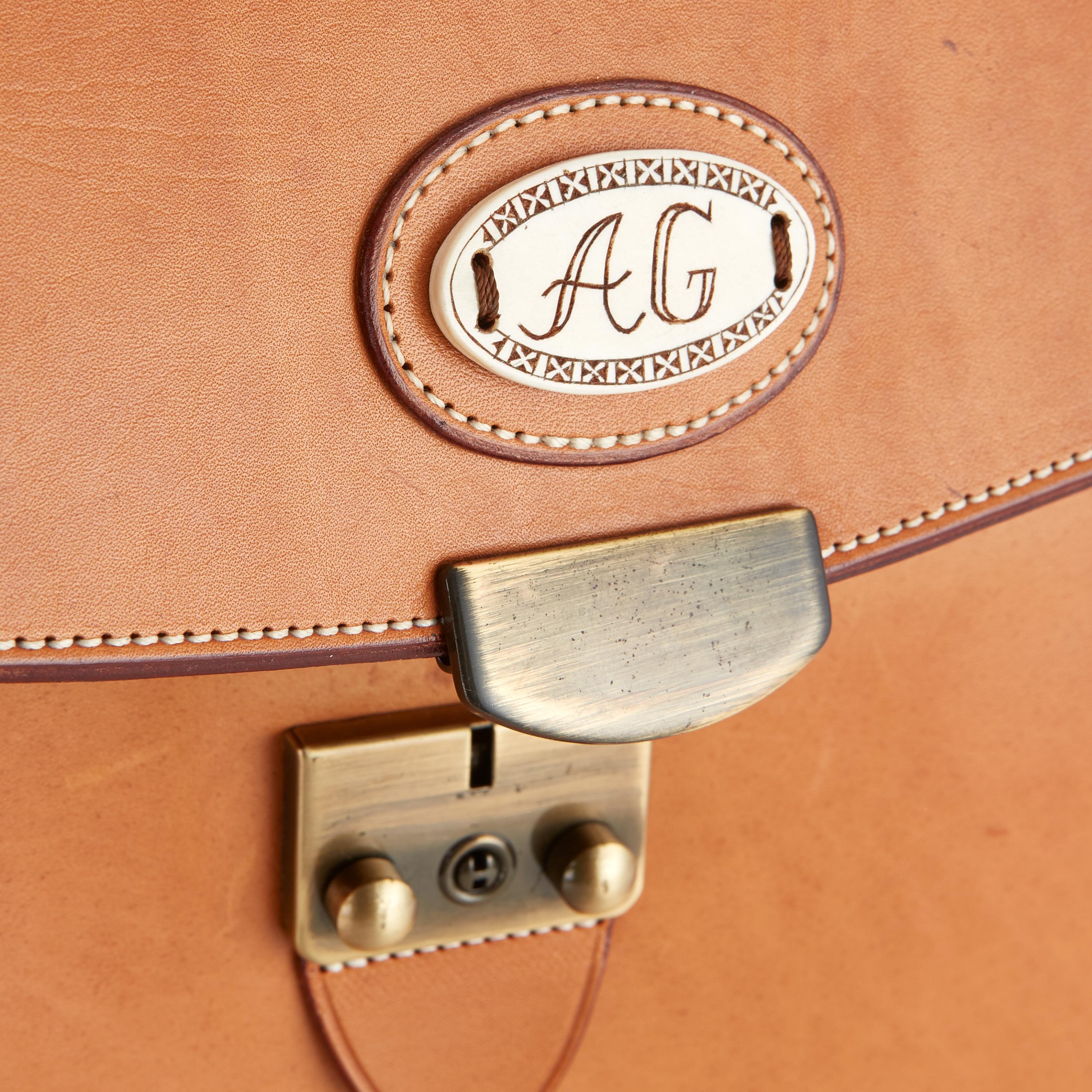 Bole Tannery Briefcase from Sweden. By appointment to H.M. The King of Sweden. Finest leather briefcases in Sweden. Strap handle. Interior compartment. Front document pocket. Reindeer emblem with initials. Lock from Italian brass. Light. Measures: