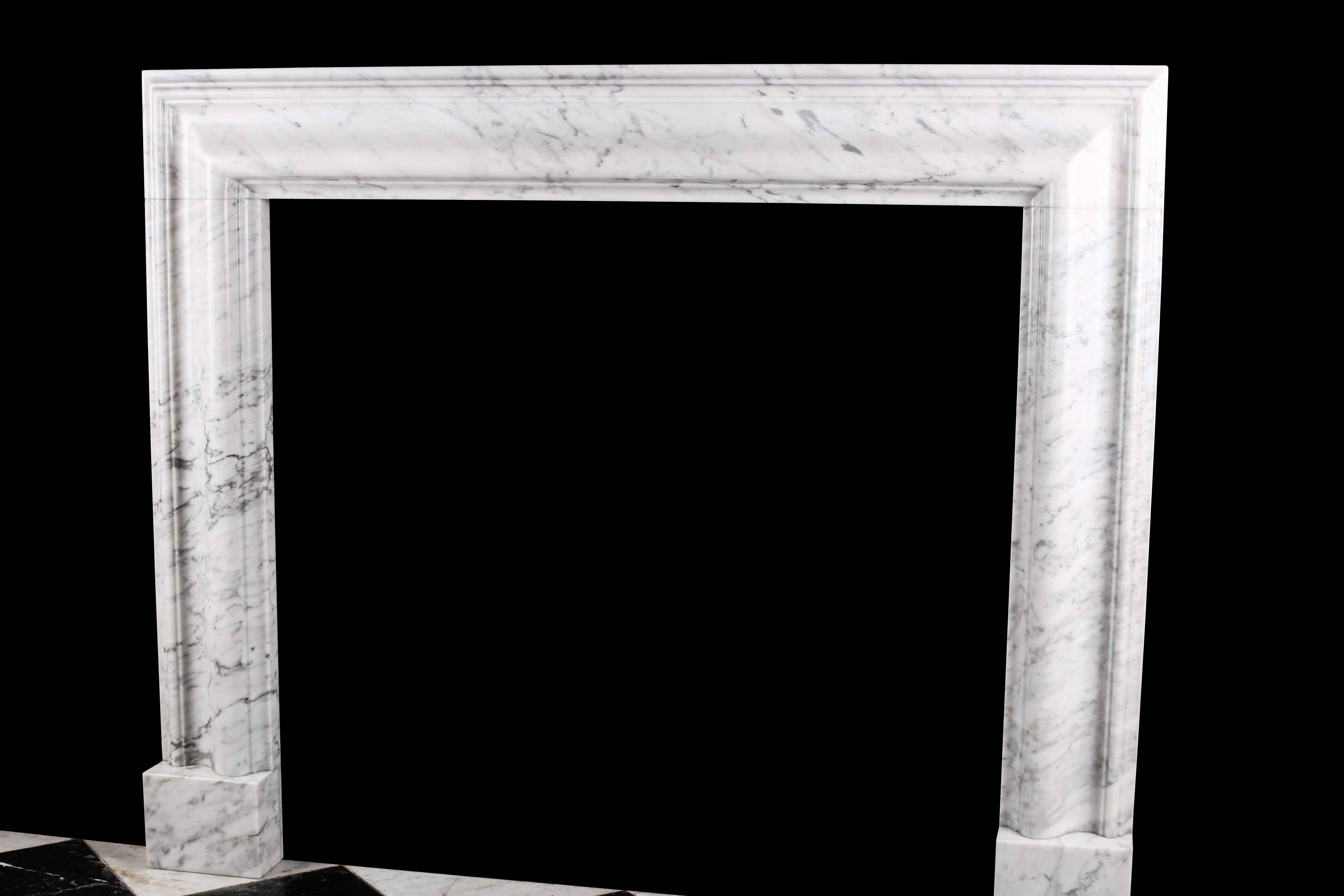 A bolection fireplace surround of bold proportions with very finely carved columns with a rising ogee edging, which are supported on substantial foot blocks, in high quality Italian white Carrara marble, in the English Queen Anne design.
Produced