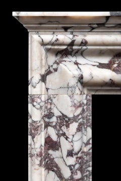 bolection fireplace produced in Italian Breccia Viola marble by Ryan & Smith