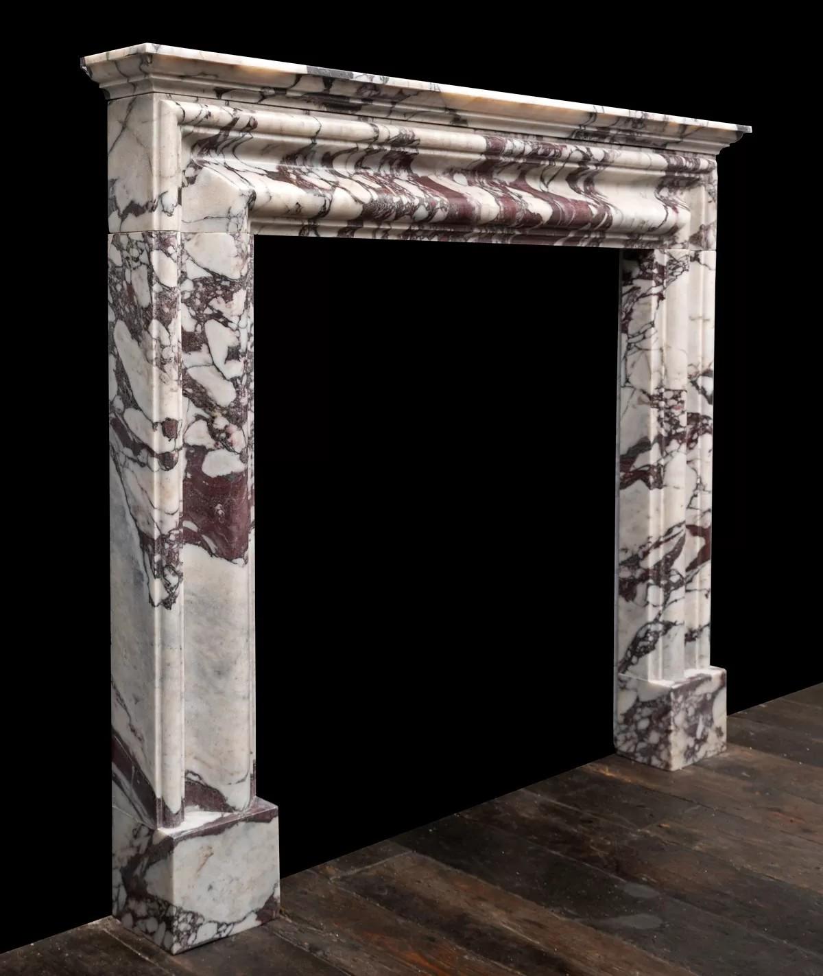 Baroque Revival bolection fireplace produced in Italian Breccia Viola marble by Ryan & Smith For Sale