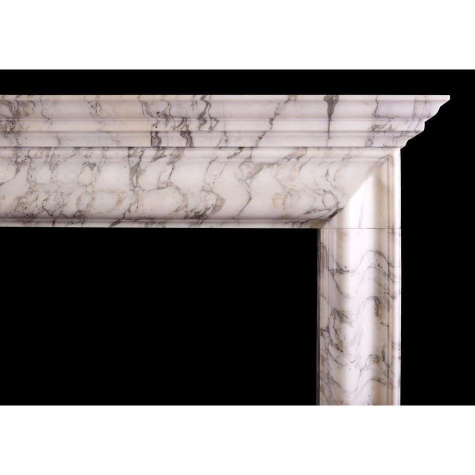 An English bolection fireplace with moulded shelf above. Shown in Italian Arabescato marble, could be made in other marbles or limestones if required. English, modern. N.B. May be subject to an extended lead time, please enquire for more
