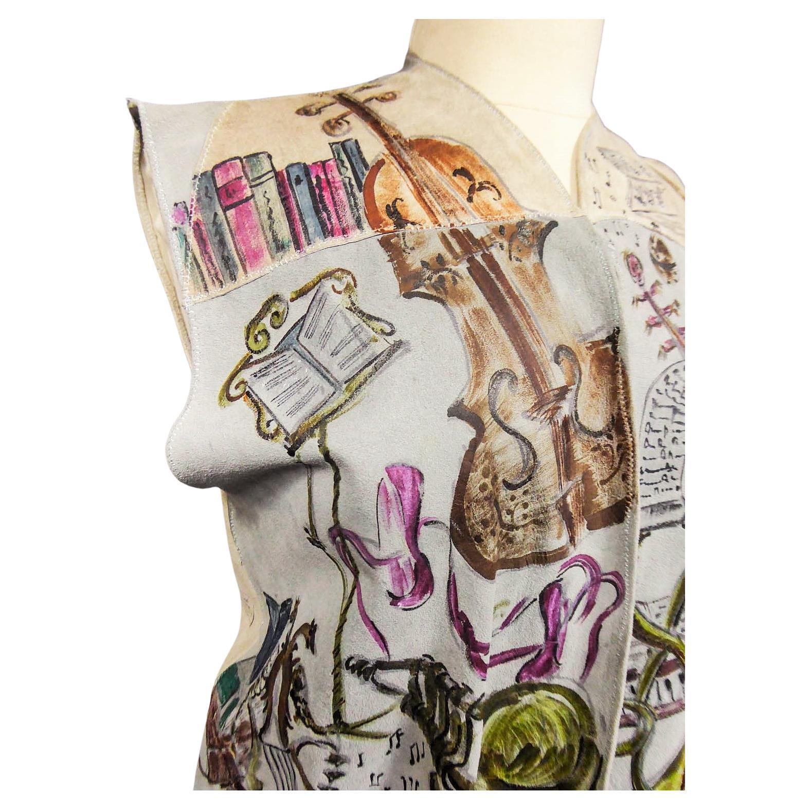 Circa 1940/1950
France

Light blue and beige suede sleeveless waistcoat entirely hand-painted on a musical theme probably signed by René Gruau. Commissioned for a play in the late 1940s. Two brown suede pockets on the front represent the body of a