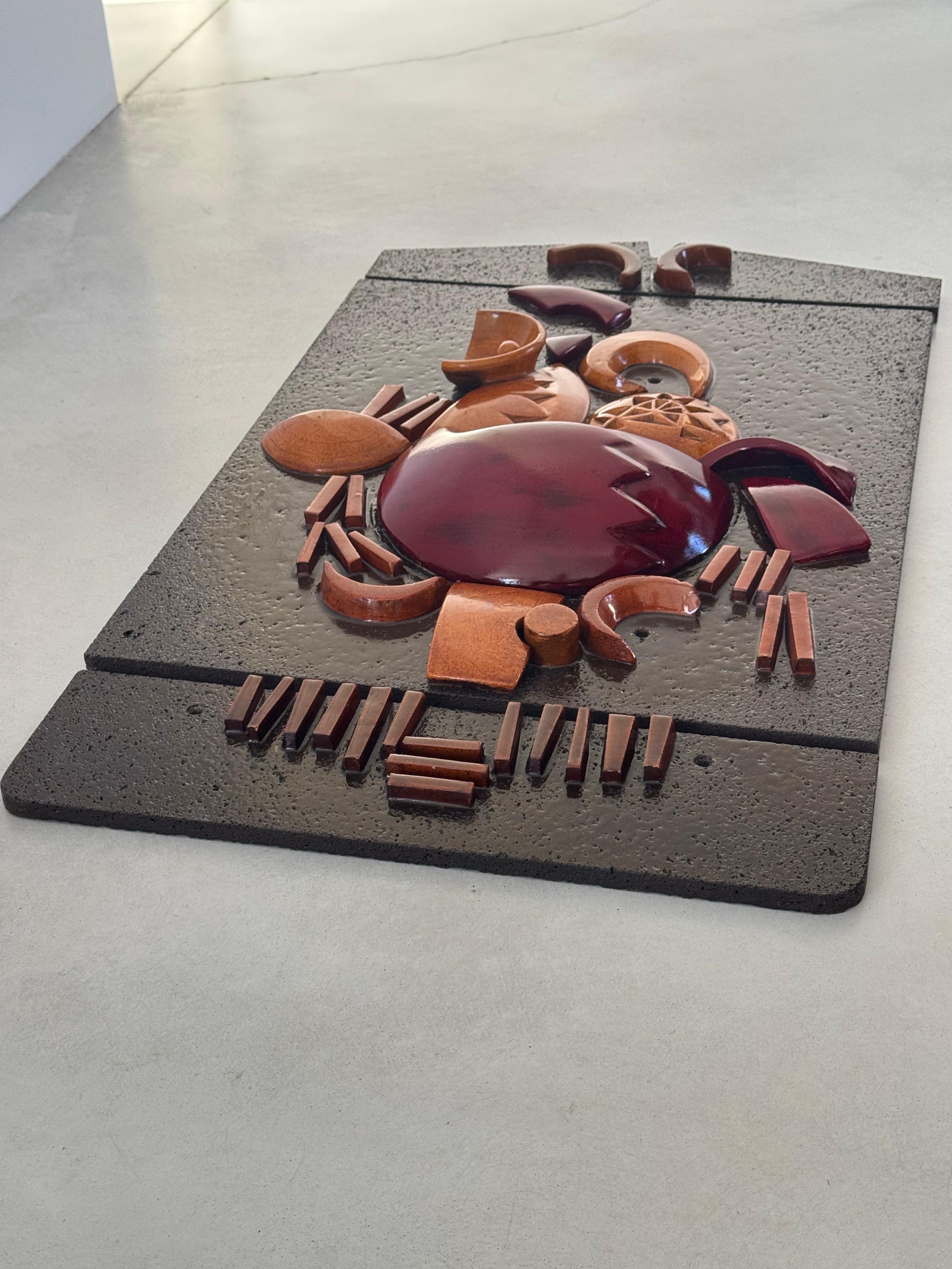 Work by Boleslaw Danikowski.

Beautiful wall decoration, lava stone and enameled ceramic.
Depicting a stylized rooster relief. Shades of red and orange ceramic on an enameled lava stone background.

Unique work, was purchased in the 1970s in the