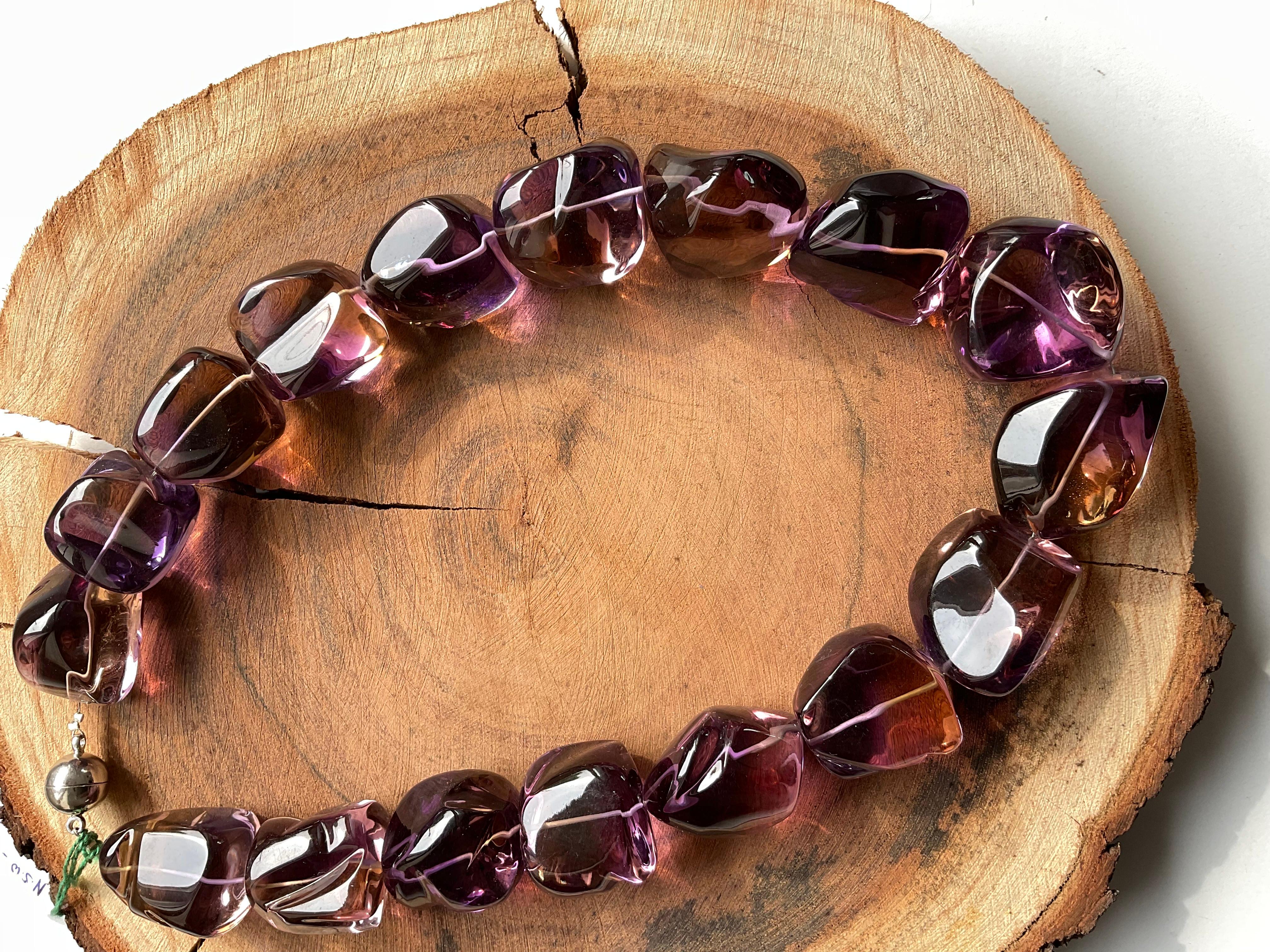 Top Quality Natural Ametrine Tumble beads Necklace
Size : 23 X 24 To 28 X 34 MM 
Weight : 1770.65 Carats
Length Of Necklace : 18 Inch 
Pieces : 17 Gems 