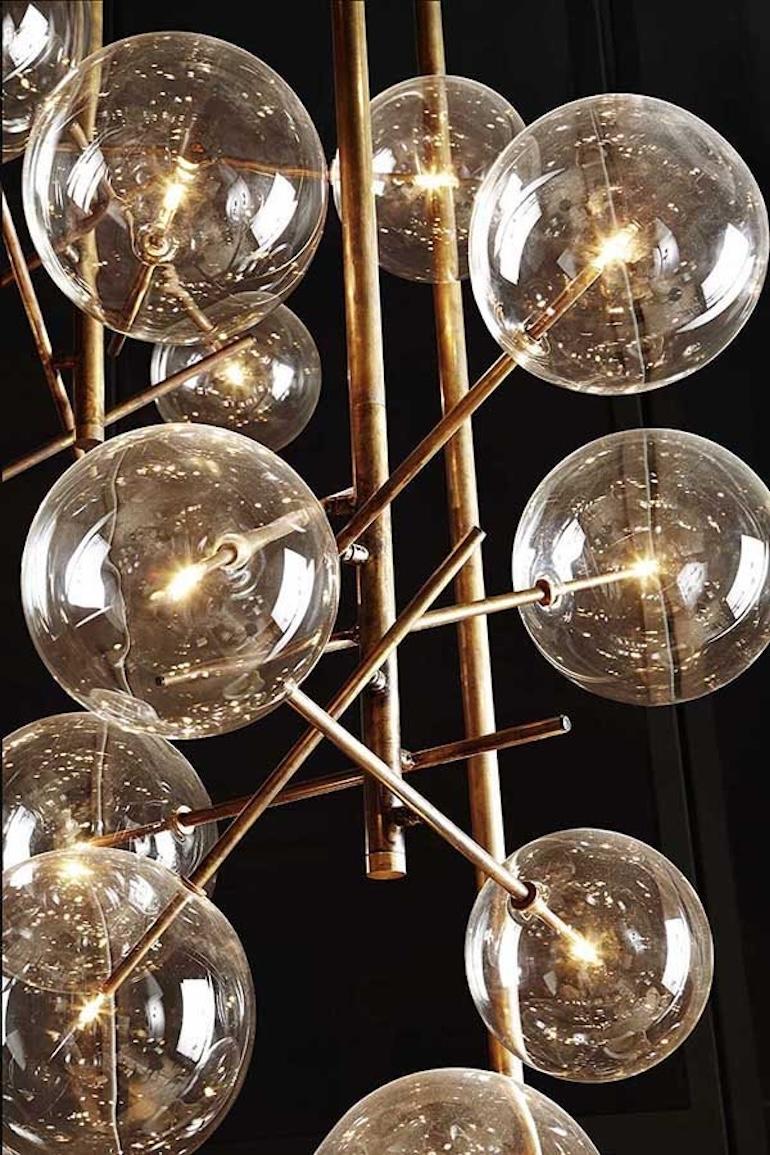 Bolle Chandelier with 4 Glass Globes & Burnished Brass Structure
Designed in 2014 by Massimo Castagna

Hanging lamp with dimmable LED light with 4 transparent mouth-blown glass spheres. Metal parts in hand burnished brass. The height can be