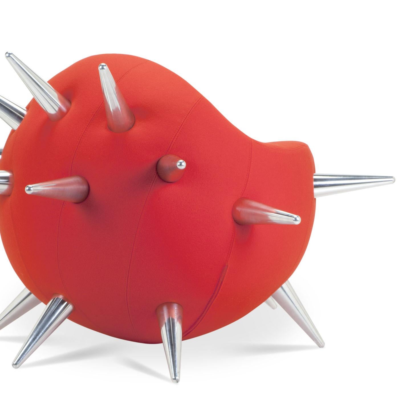Bomb's iconic design is inspired by an object of destruction to make us reflect on the drama of war and to stir up thoughts about peace and life. Featuring a round shape and five aluminum tips, Bomb armchair is shown here in red, but it is also