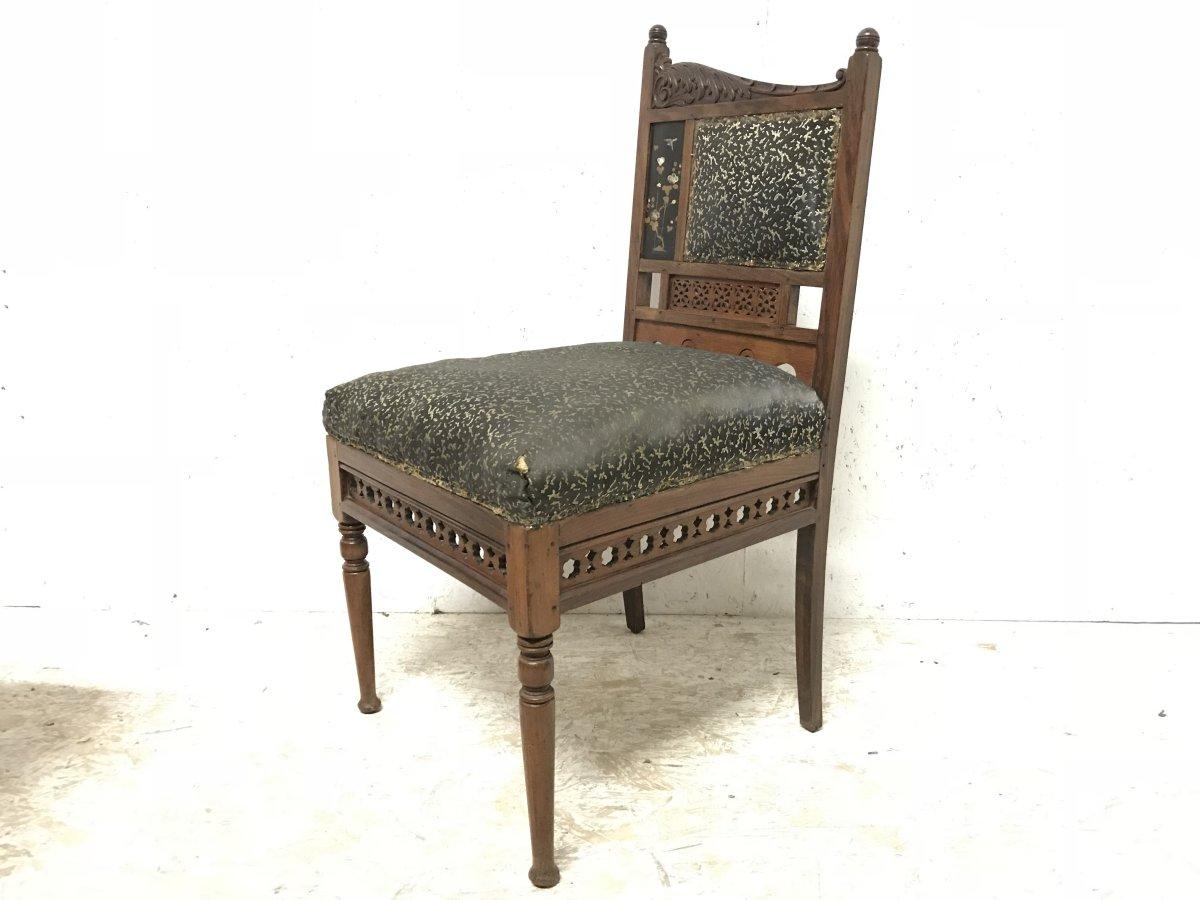 Bombay Art Furniture Co. An Anglo-Japanese side chair with turned finials at different heights and a sweeping carved acanthus leaf scrolling down. An inset lacquer panel with a bird hovering above floral details with Mother of Pearl inlays.