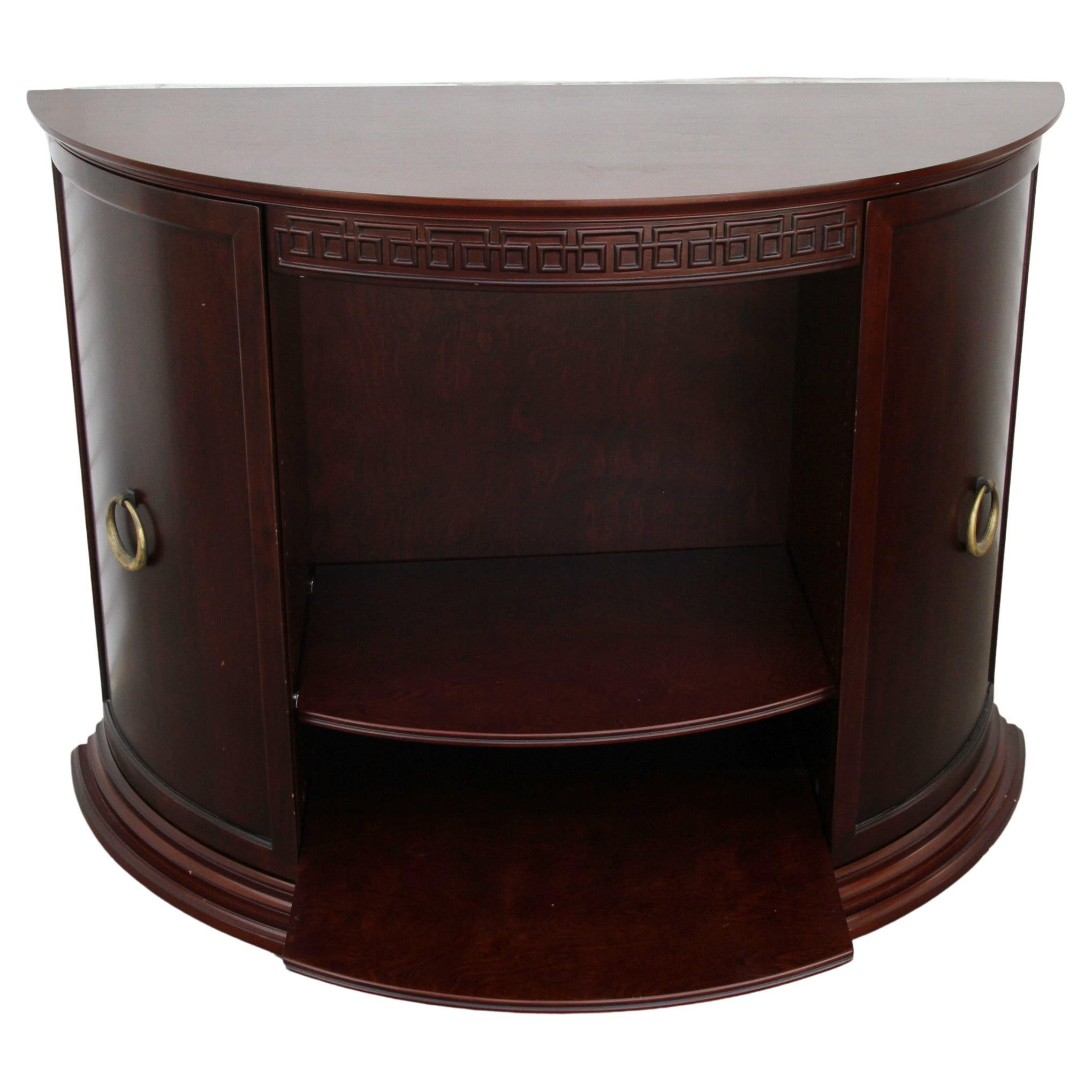 Bombay Co Demilune Entry Table

Nice cherry finish entry or media cabinet by the Bombay Company.  Fertures two closed cabinets with shelving  and one tablet pull out at base. Brass pulls. Greek key details at top. 

