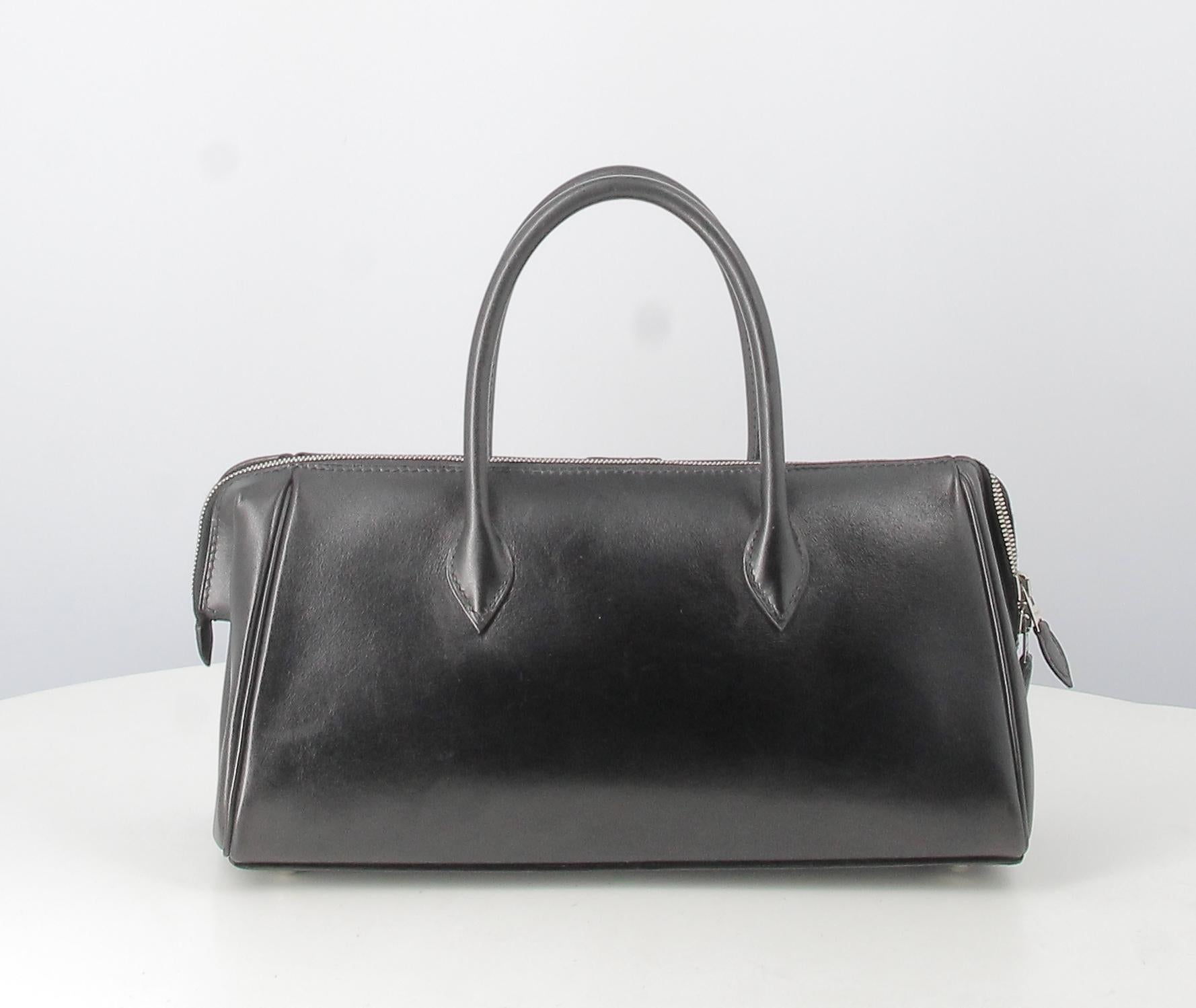 Bombay Hermes Handbag Black leather 

- Good condition. Shows some signs of wear over time.
- Hermes Bombay Handbag 
- Black leather 
- Two small rigid black leather handles
- Clasp: Silver zip 
- Inside: brown leather  Two inside pockets 
