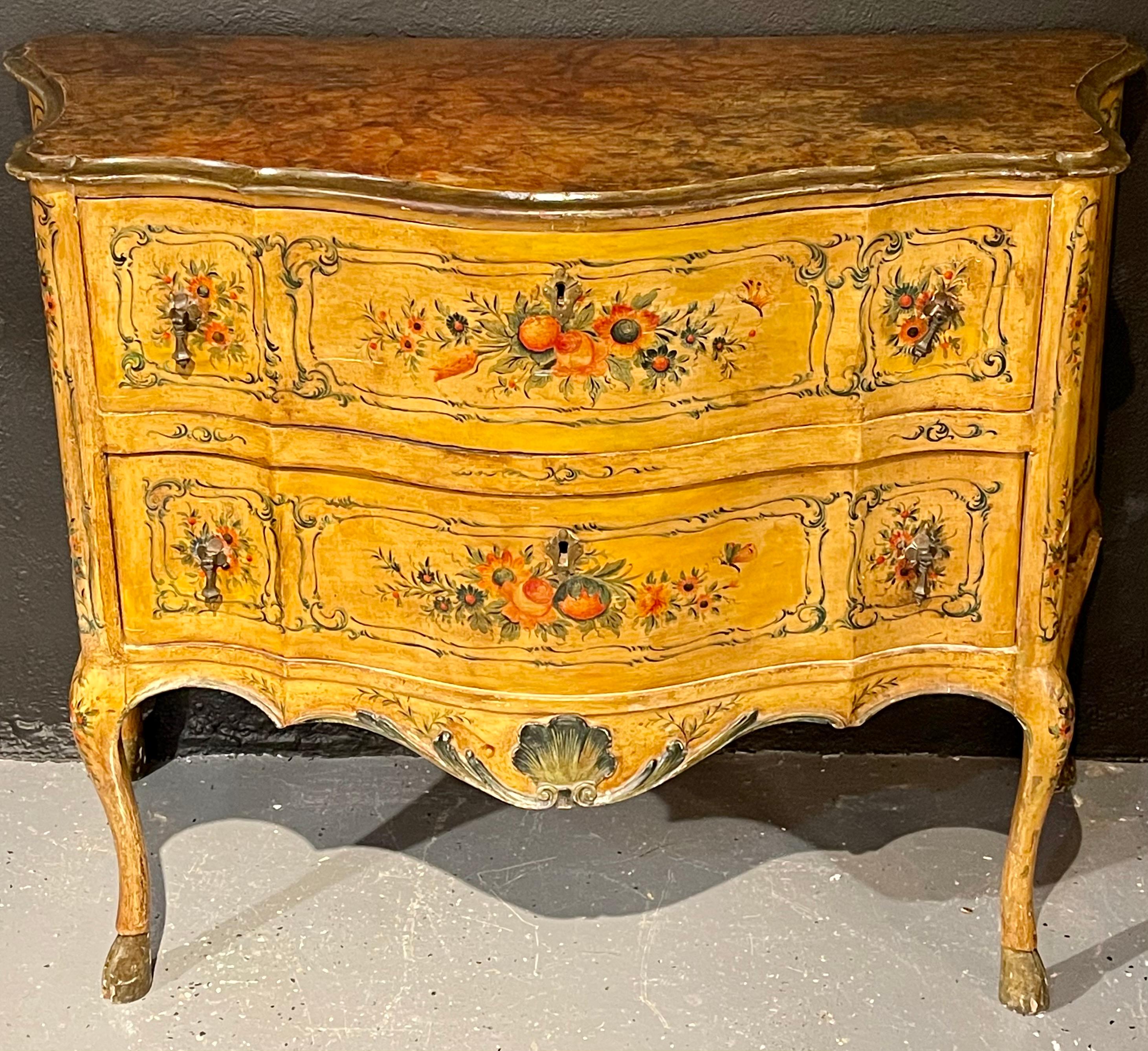 Bombay Italian commode, chest or dresser paint decorated from the late 18th-19th century. This finely designed Venetian paint decorated commode, chest or nightstand is simply stunning. The faux paint decorated marble top sitting atop a pair of