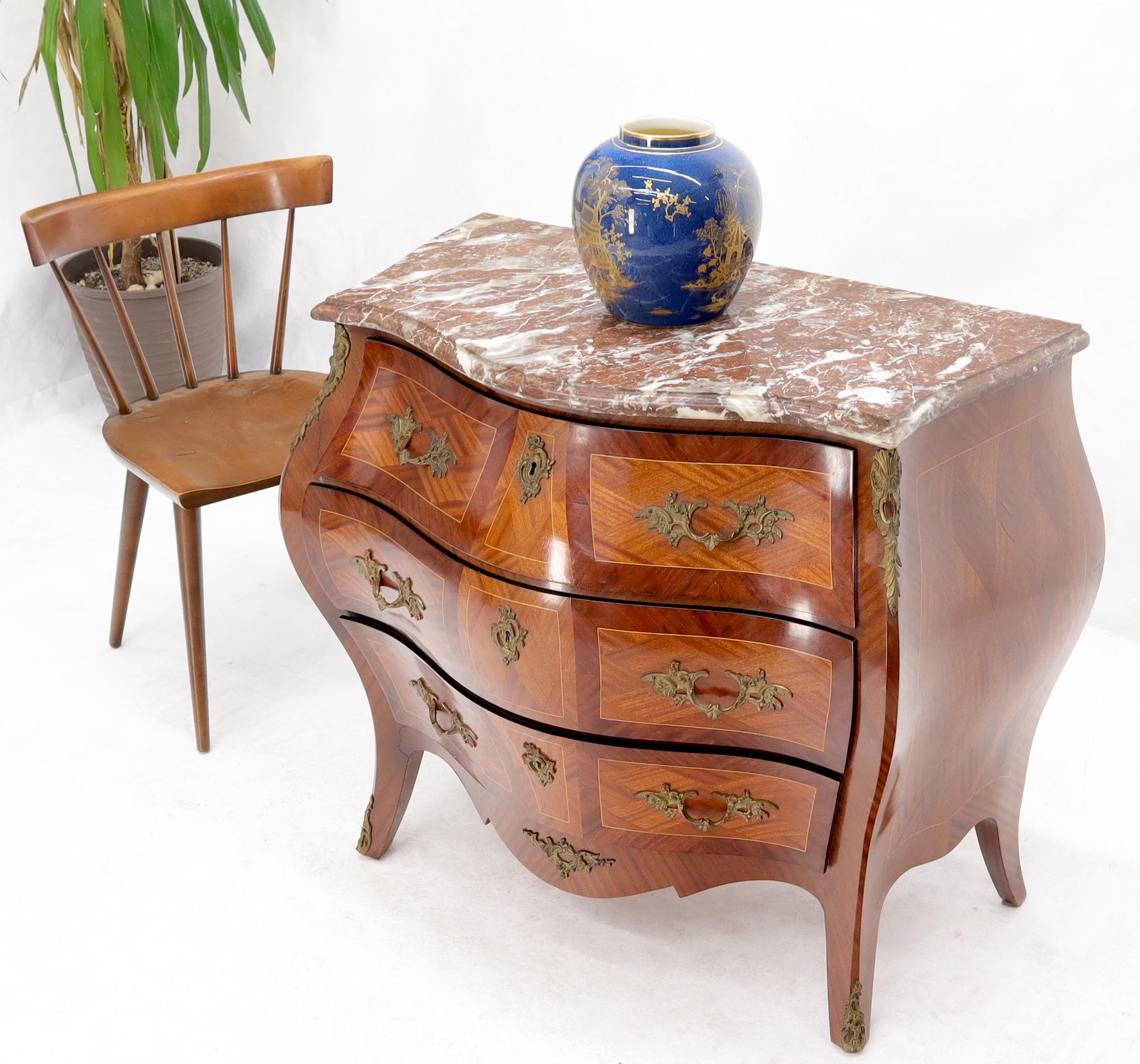 Stunning rouge marble-top French inlayed wood dresser with significant bronze ormolu. Very nice decorative piece.