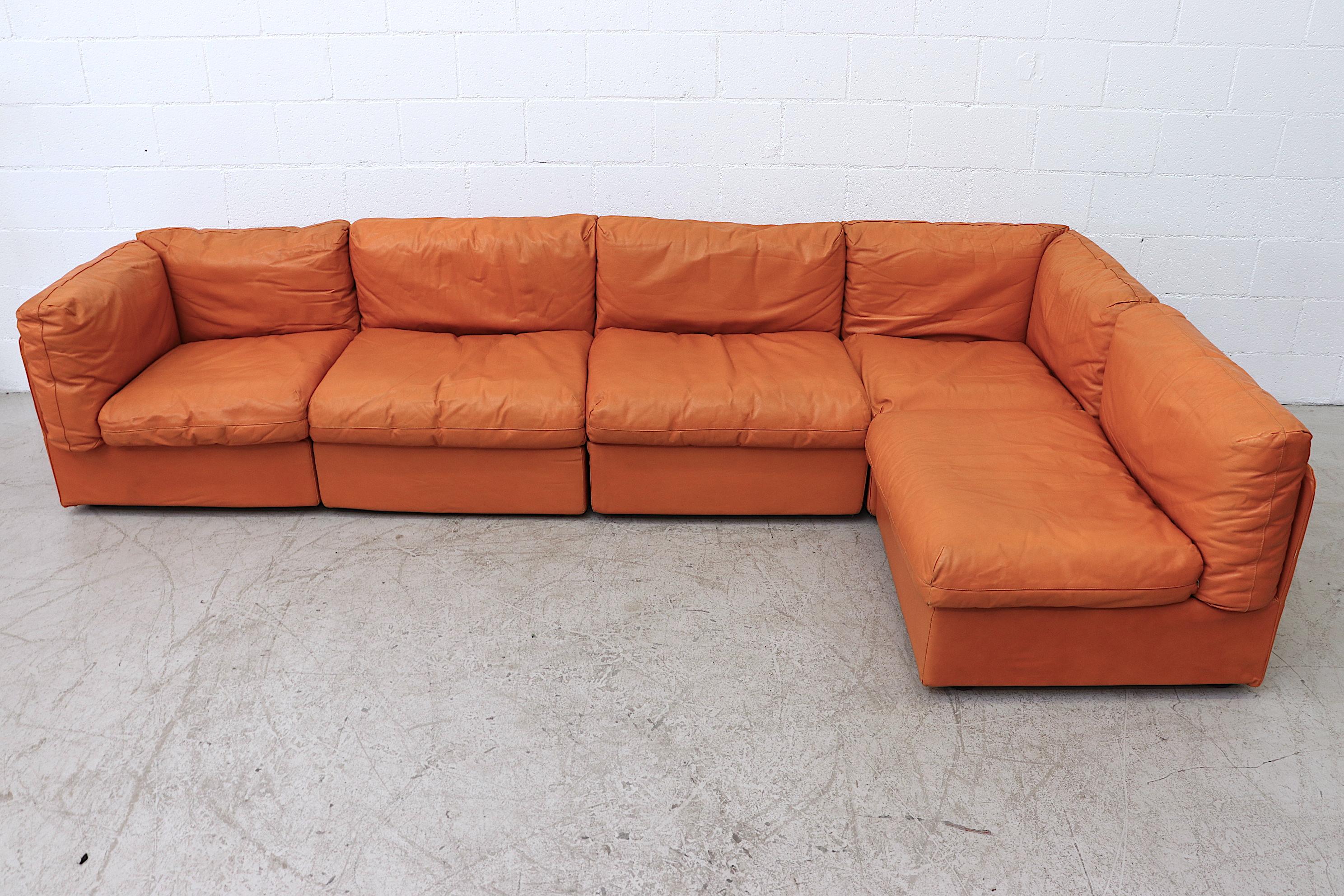 Gorgeous midcentury orange leather sectional. Produced in the 1980s by Italian Production House Bonacina, this sectional has 5 individual sections (30