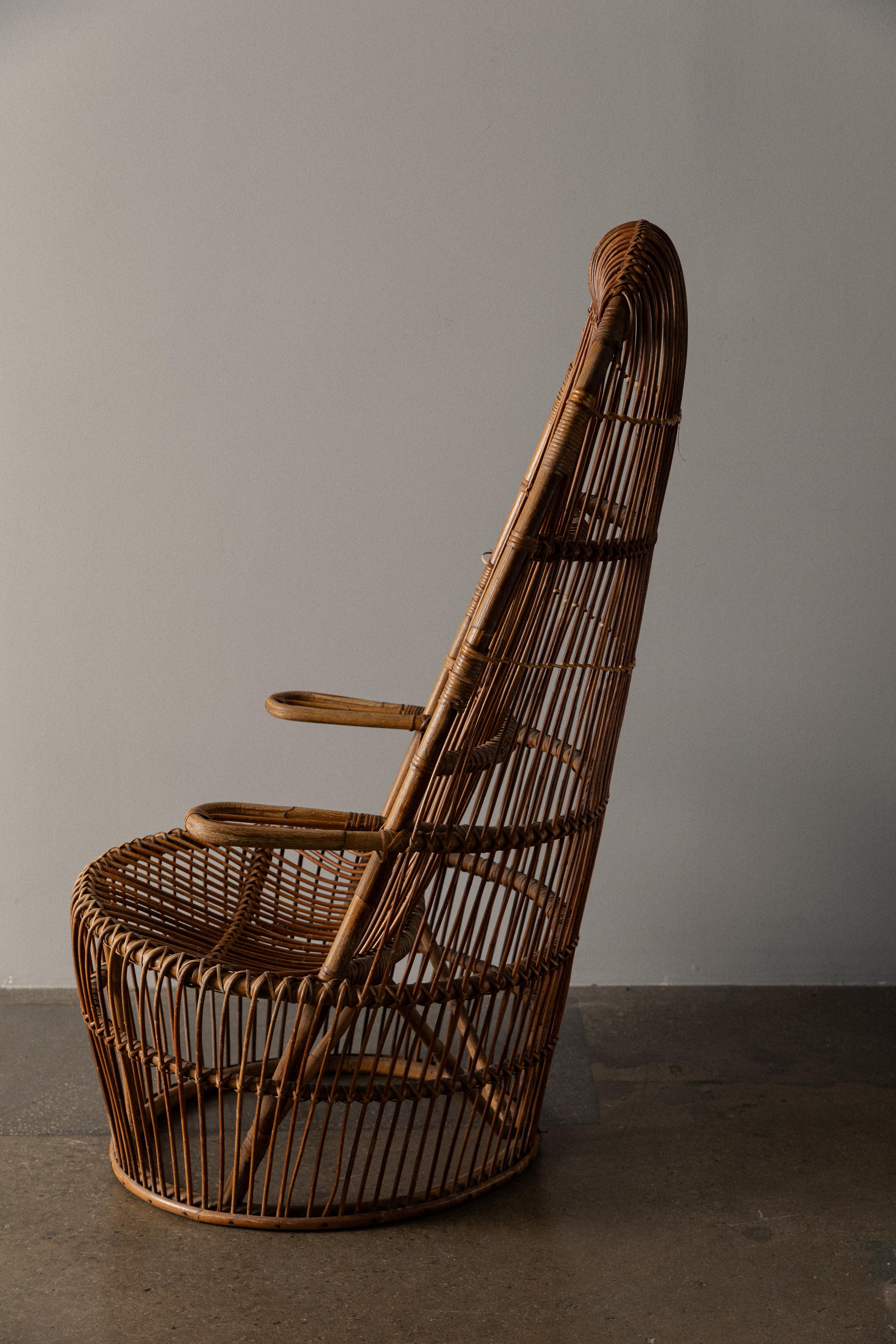 Great sculptural design highlighting the color and beauty of natural rattan. All original, manufactured by Bonacina in Italy, who also included designers such as Franco Albini. The chair is extremely comfortable and offers ample support. Chair is in