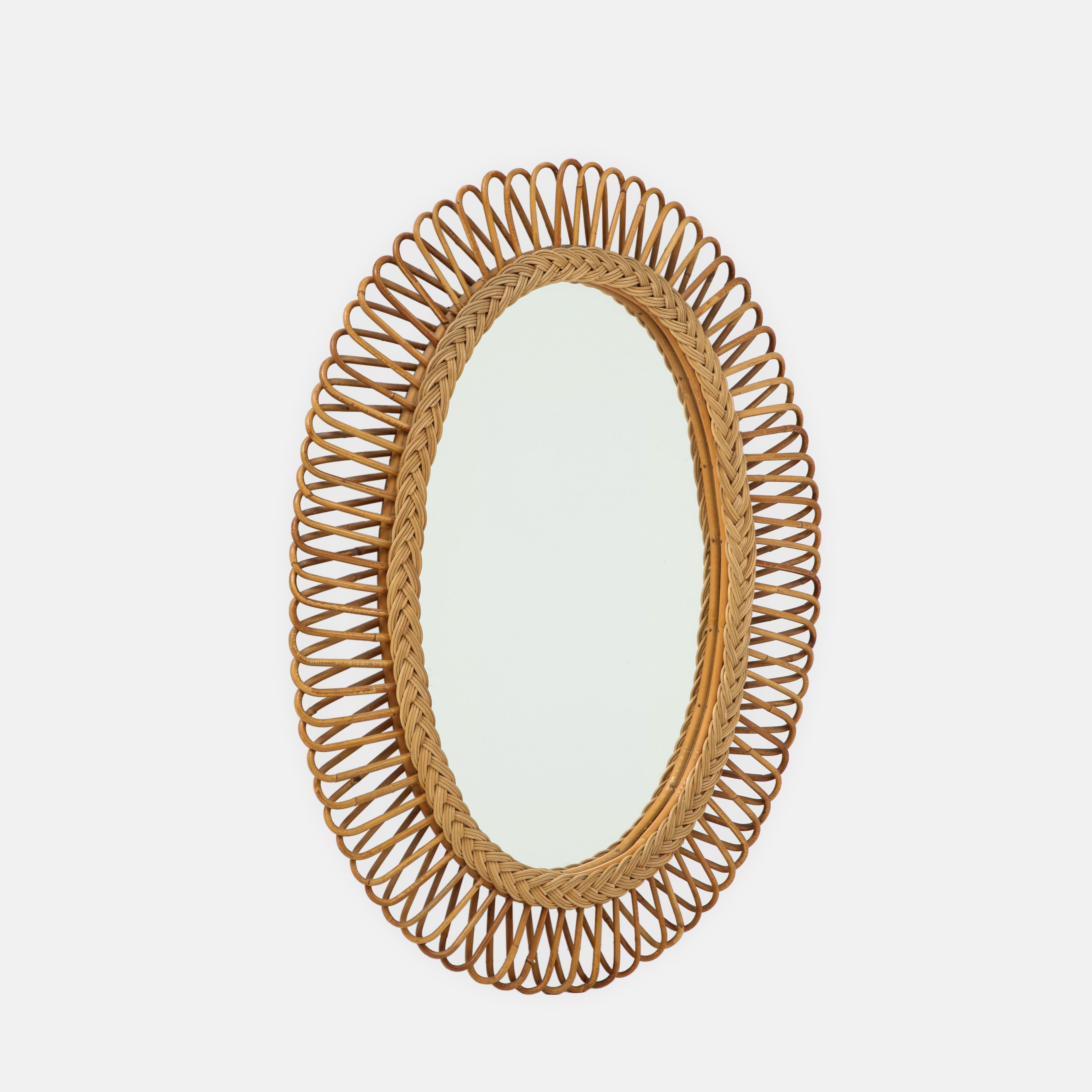 Bonacina oval bamboo and rattan wall mirror, Italy, 1950s. This chic and iconic mid-century Italian mirror is intricately hand-woven with bamboo and rattan including a lovely braid around the mirror edge.