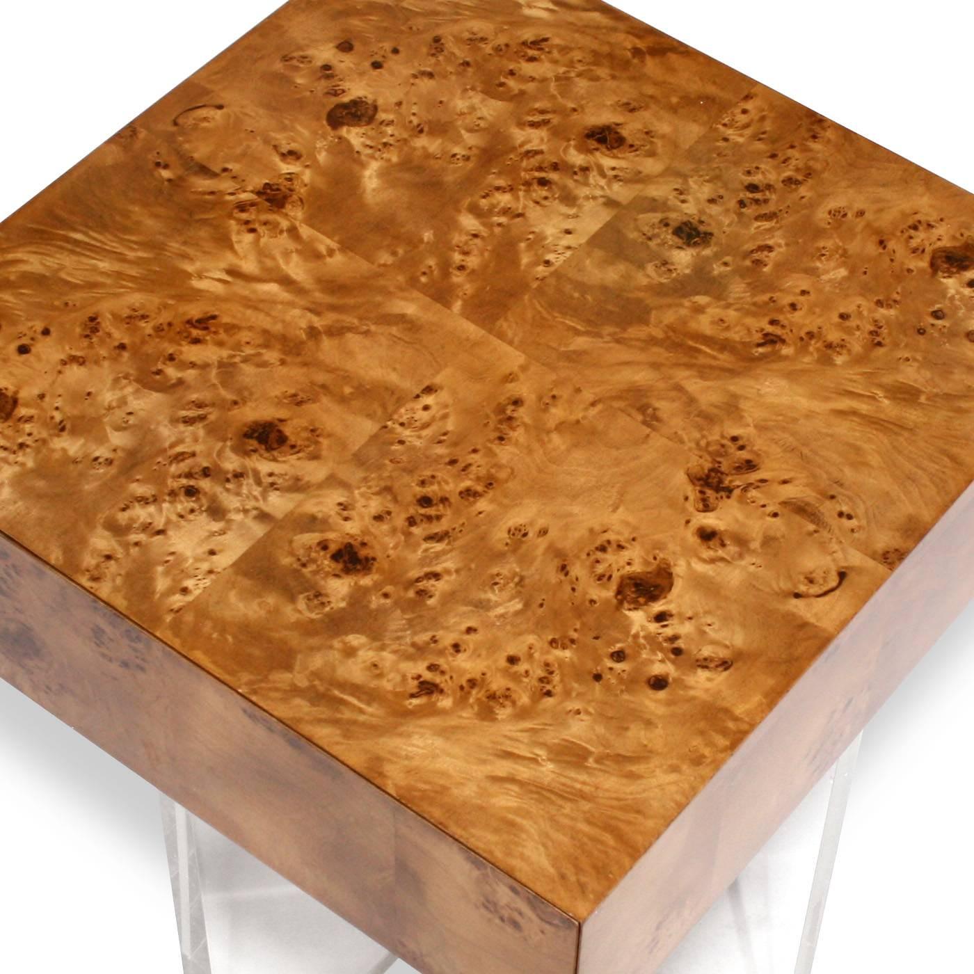 Timelessly chic. A Minimalist world of burled wood, acrylic panels, and stainless steel. Pieced, burled mappa wood floats atop a simple but glamorous acrylic base. Fully finished drawers with a hidden pull and a finished back make this piece fierce