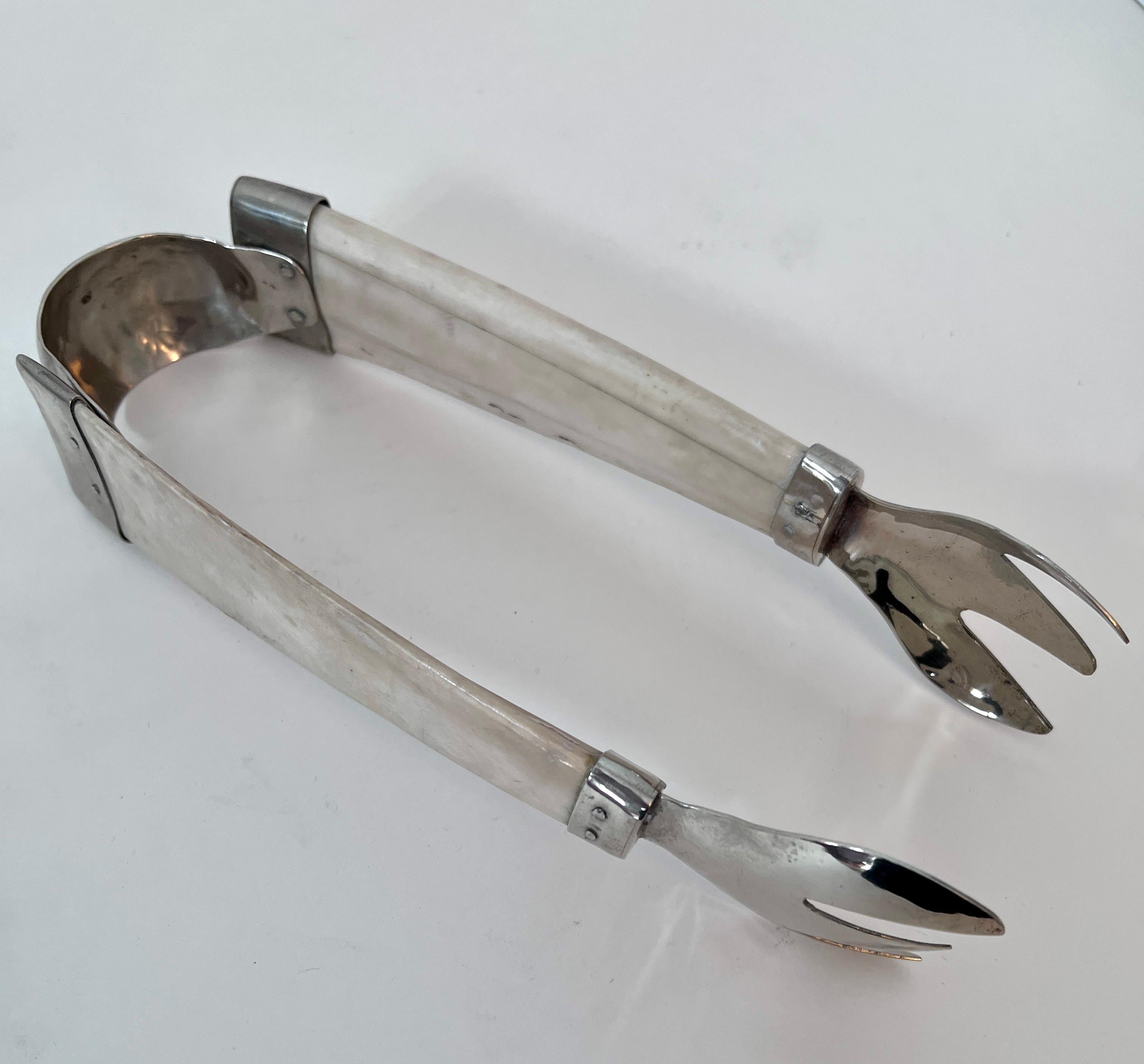 A wonderful pair of Ice Tongs made of bone and silver plate.  A compliment to any sophisticated bar.  A beautiful and unique piece.

The attention to hand detailed craftsmanship is seen throughout.