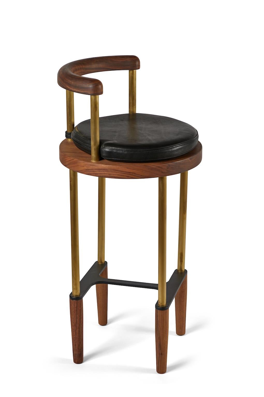 Bone bar stool in oiled walnut with brass legs and removable cushion. Made in the USA by Casey McCafferty.

Available finishes:
Oiled black walnut, oiled white oak, bleached white oak, charred ash, oxidized maple

COM (customers own material)
