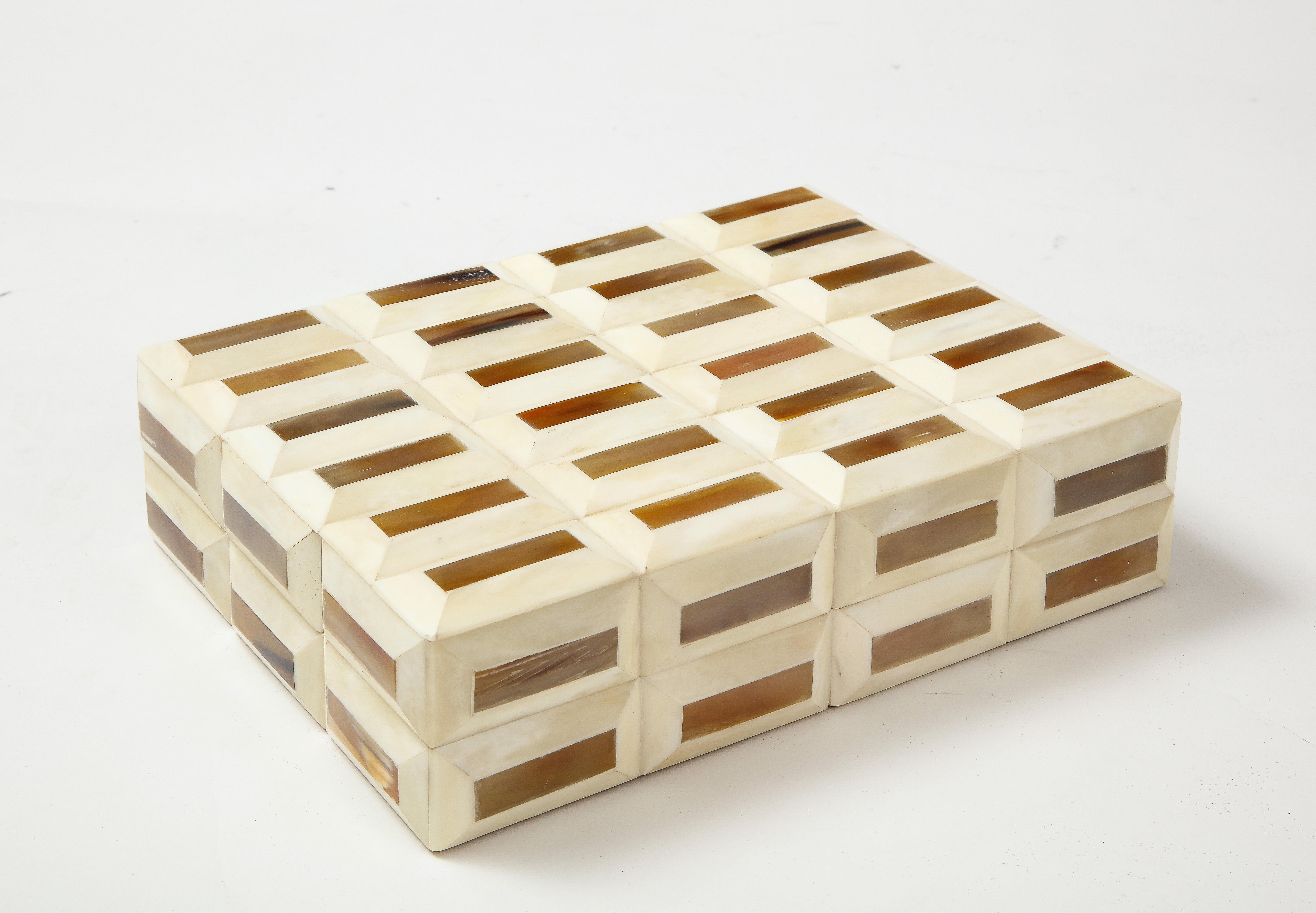 Rectangular bone box featuring rectagular dimensional tiles with horn inlay tops. Lined in wood.