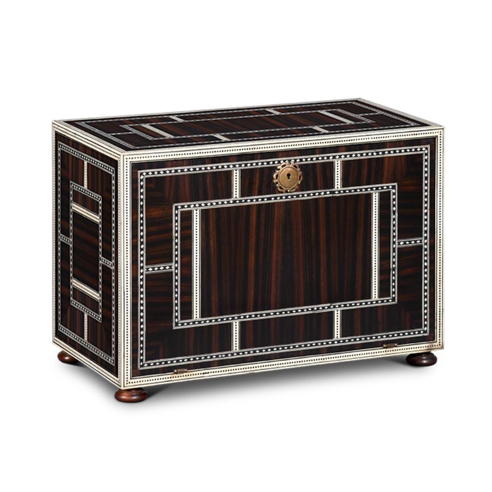 Inspired in antique cabinets, this piece is adorned with bone inlays with ebony and brass ironwork. This emblematic piece is sure to adorn any space.