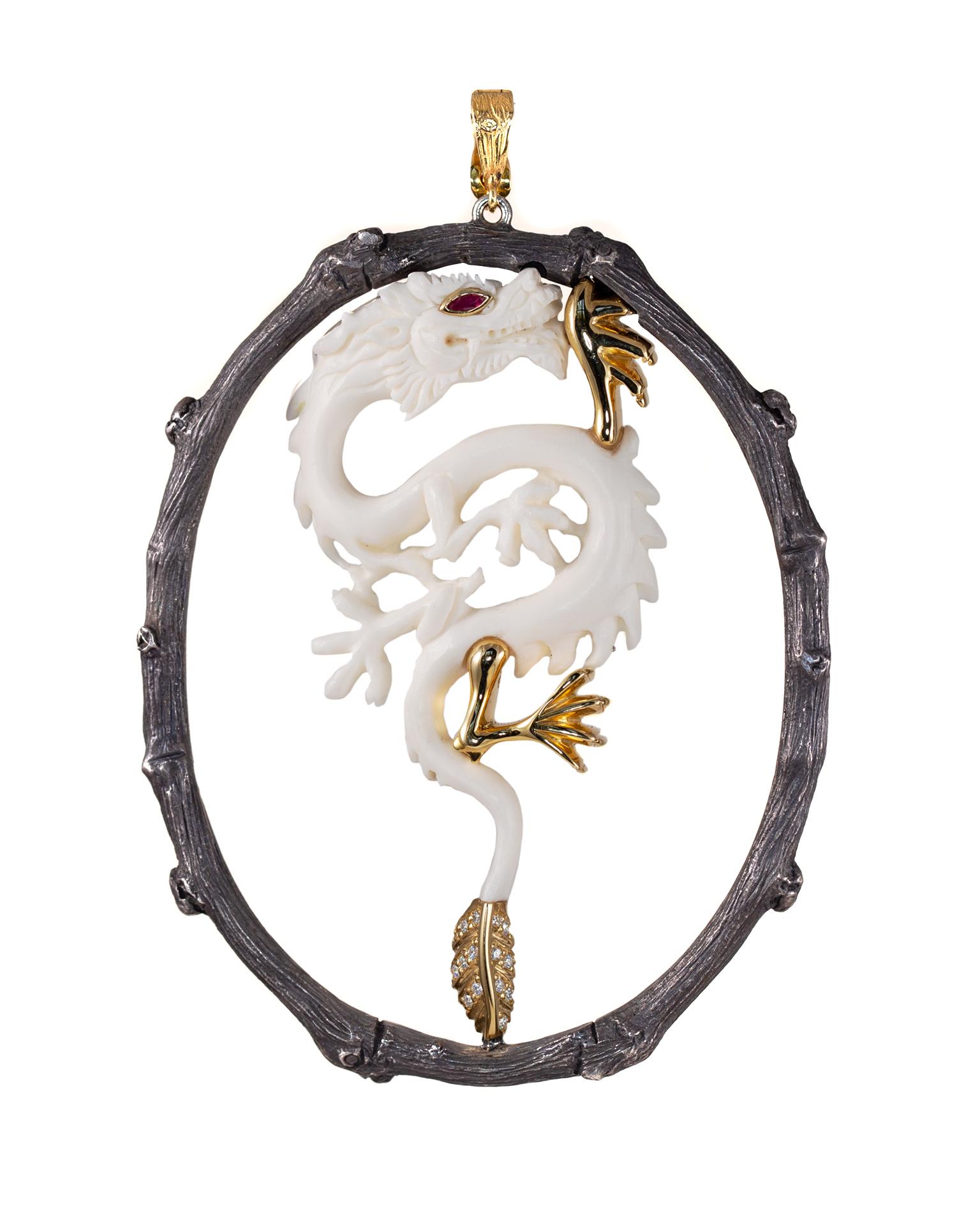 This dragon pendant is composed of carved cow bone and 18k yellow gold in black oxidized sterling silver frame. It features a .05 carat ruby eye and approximately .18 carat total weight diamonds. 

The Spirit Animals Collection features miniature