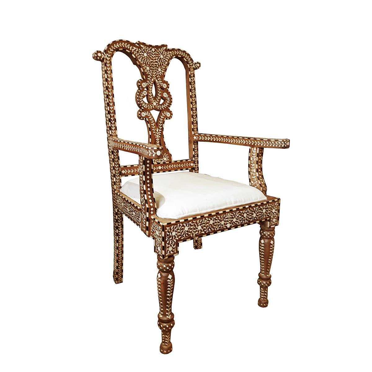 A beautiful armchair, handcrafted in India out of aged teak wood and cruelty-free sourced animal bone inlays. 

Inlay is ancient decorative technique that involves embedding delicate, hand-carved pieces of bone (in the beginnings it was ivory or