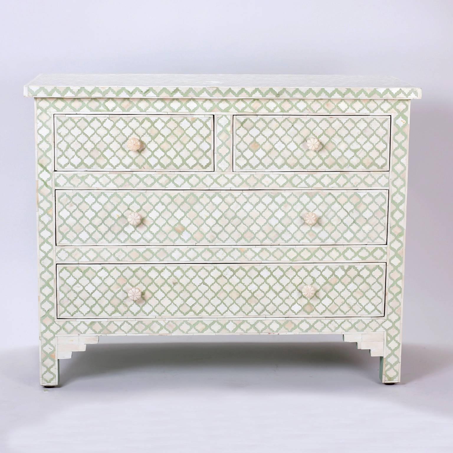 Stand out Indian chest of drawers with dyed green and natural bone inlaid in a repeating cartouche mosaic design throughout. Having Classic form, charming floral pulls, and stylized bracket feet.
 