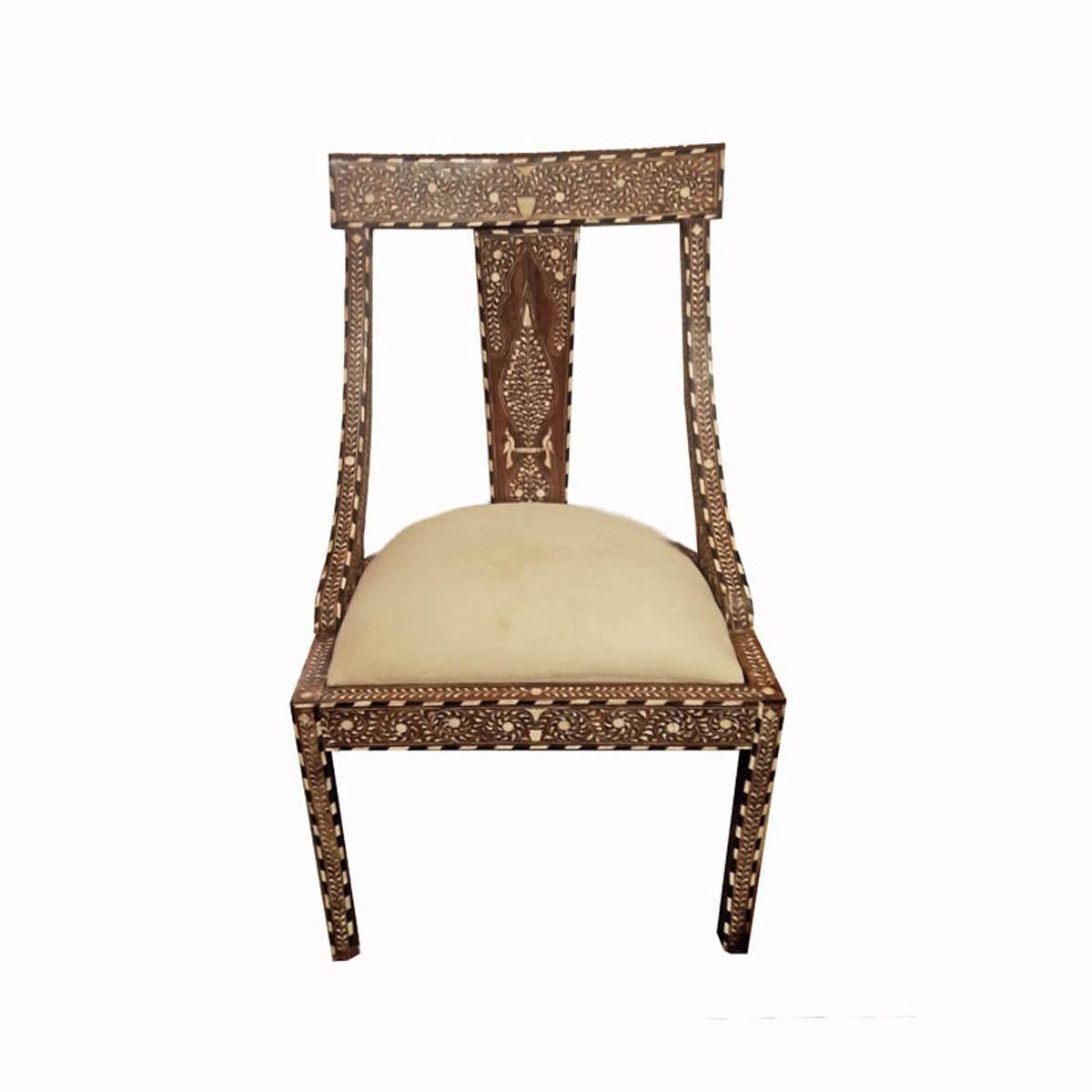 A beautiful teak chair with bone inlays, handmade in India. Classic inlay pattern throughout. The seat is detached and covered in neutral muslin, so it can be reupholstered to taste and to coordinate with any decor. Circa 1970. 

Two available.
