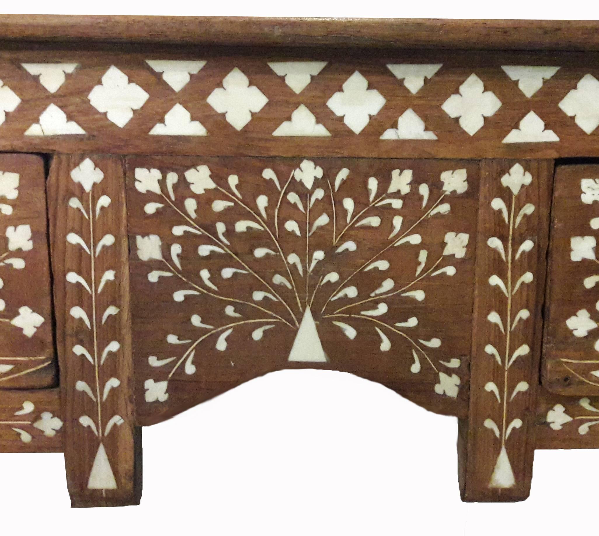 A teak desk from India, with bone inlaid traditional pattern. Two drawers with porcelain pulls, side stretchers. Ideal as a desk, console or occasional table.