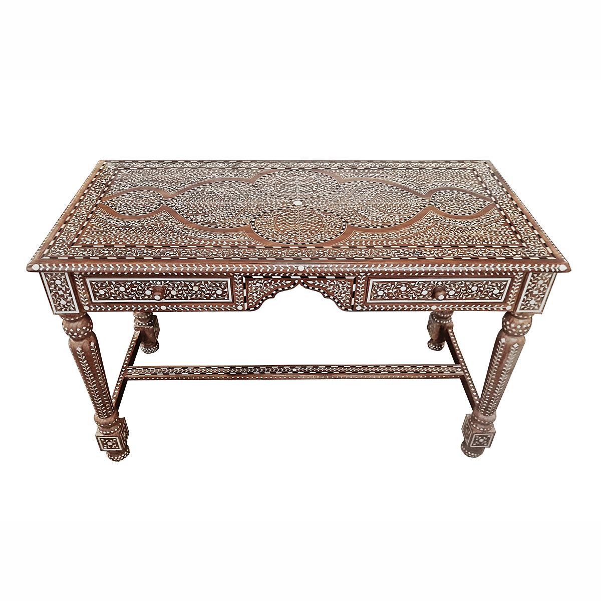 A beautiful writing desk, handcrafted in India out of aged teak wood and cruelty-free sourced animal bone inlays. 

Inlay is ancient decorative technique that involves embedding delicate, hand-carved pieces of bone (in the beginnings it was ivory or