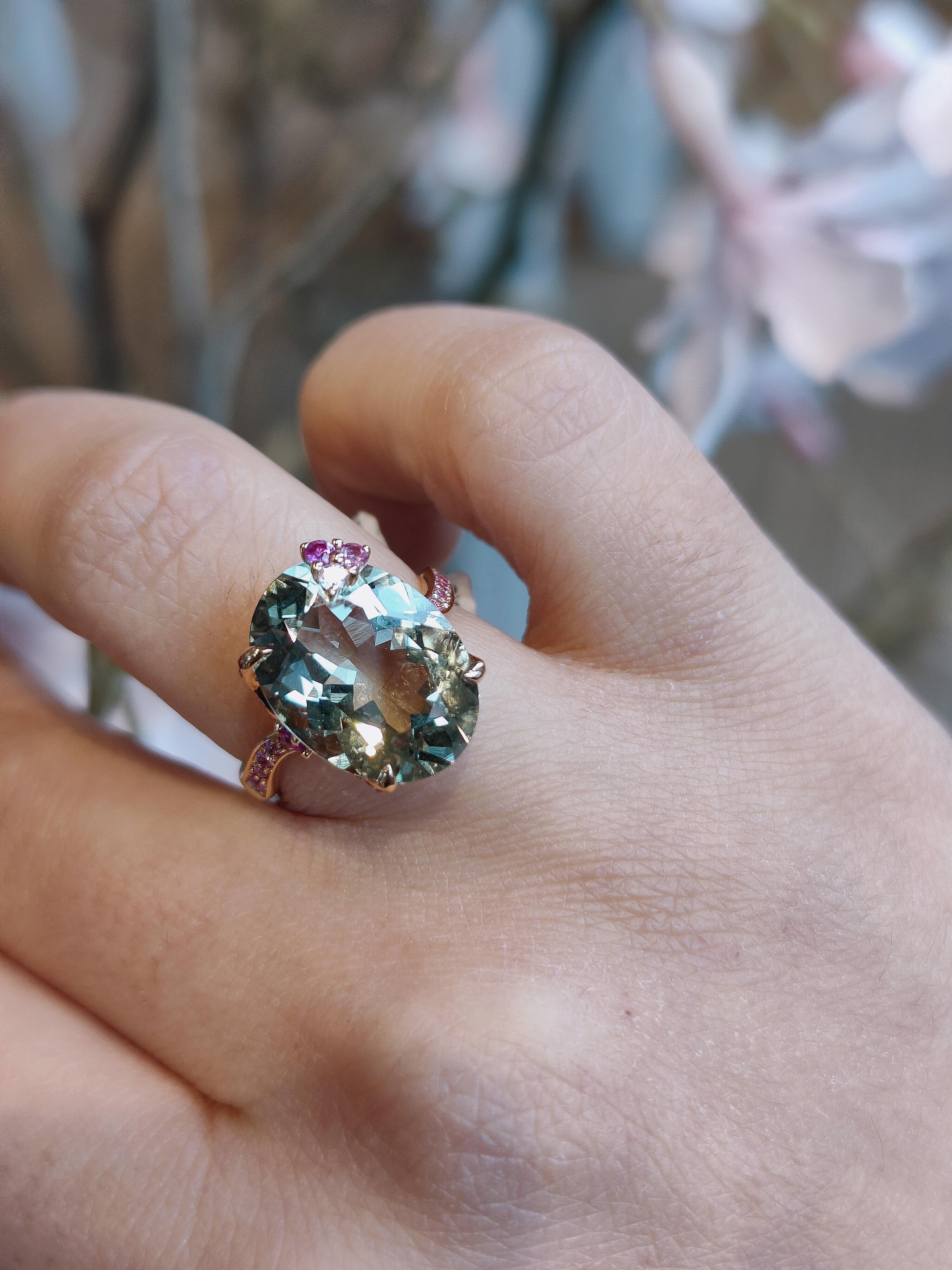 This Bonebakker ring is made in 18 karat rose gold featuring a 15mm x 11 mm oval cut prasiolite, pink sapphires and 0.0.3ct of diamonds.  Prasiolite is a green amethyst that radiates energy and balance. This big and colourful stone will sparkle in