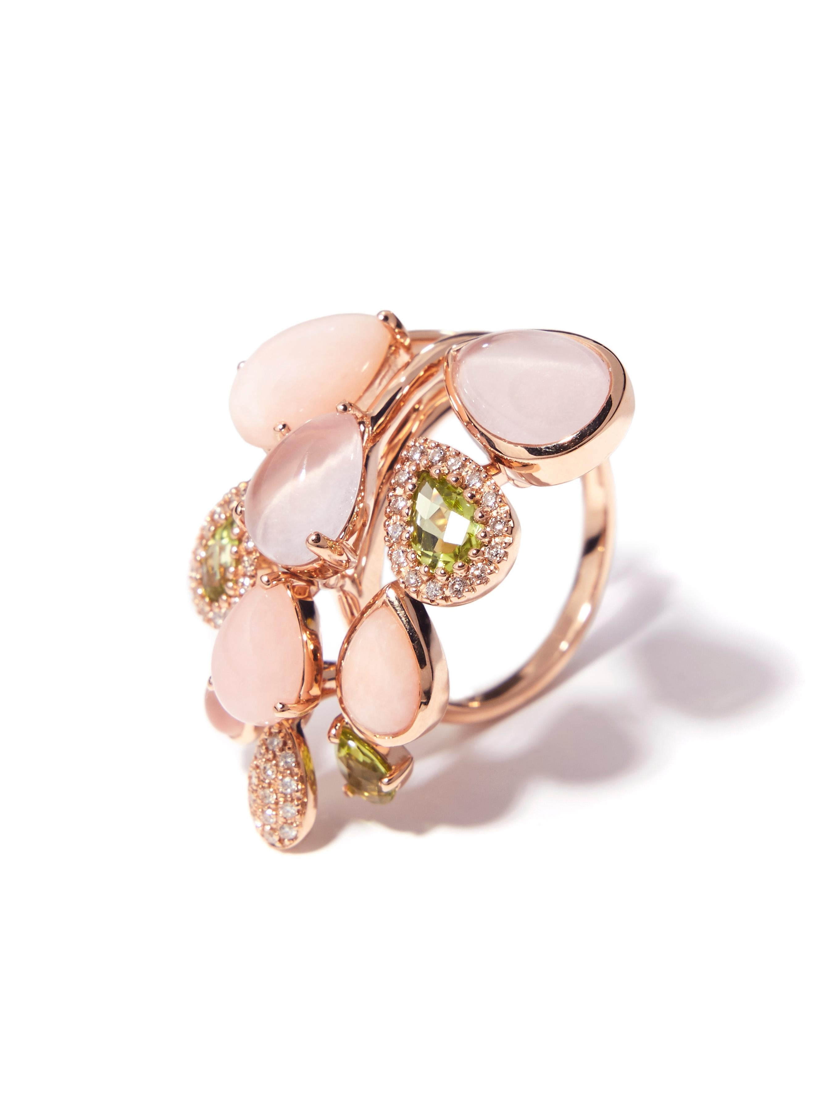 This 18 karat pink gold ring features 3 pear shaped faceted peridots. A halo of 
diamonds enhances the lively soft green of the peridots. Peruvian pink opal, pink quartz and a tiny pave set diamond drop emit graceful femininity and a whimsical sense