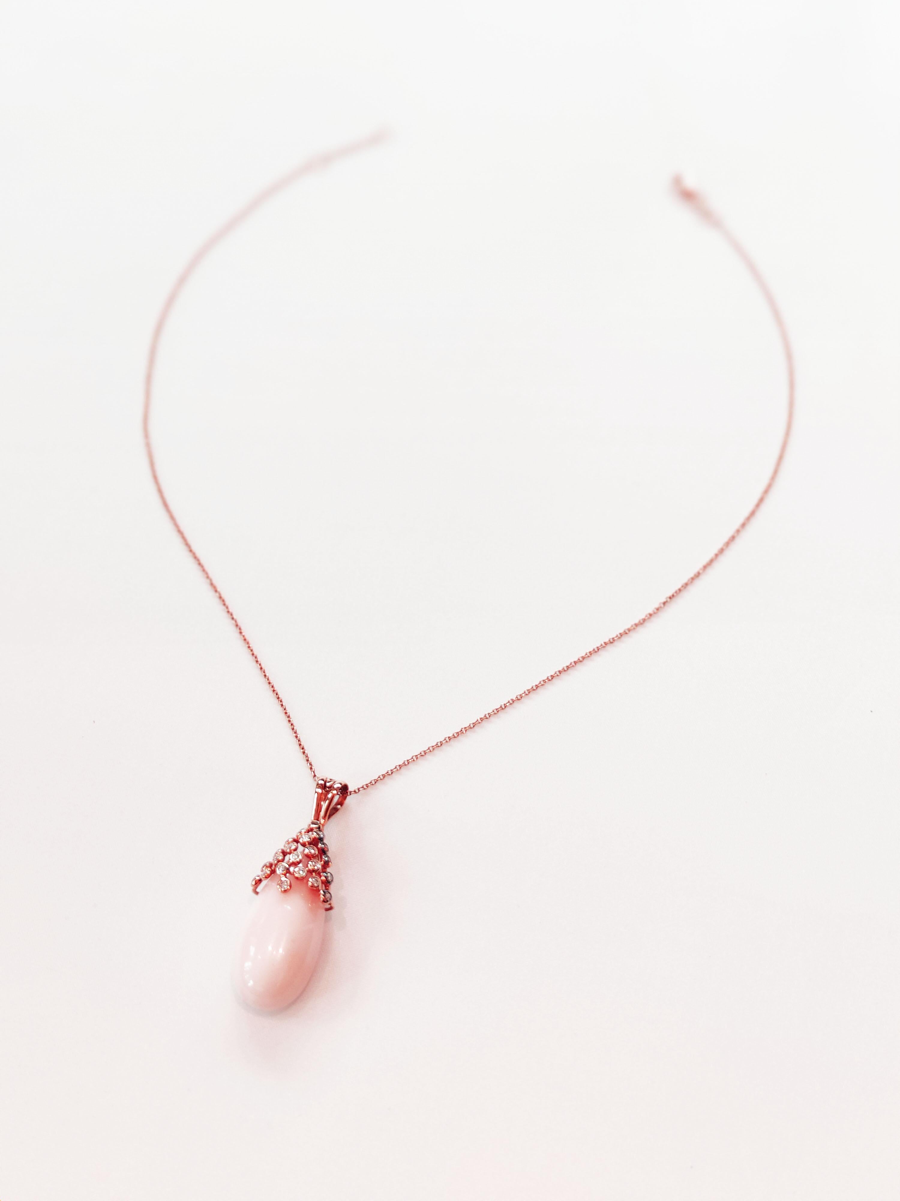 Stunning, delicate, 18 karat rose gold Angel skin coral pendant with filigree.
11 diamonds, a total of 0.20 carat, are set on the pendant. The total length of the pendant including bail is 44mm. The coral is slightly more pink than on the