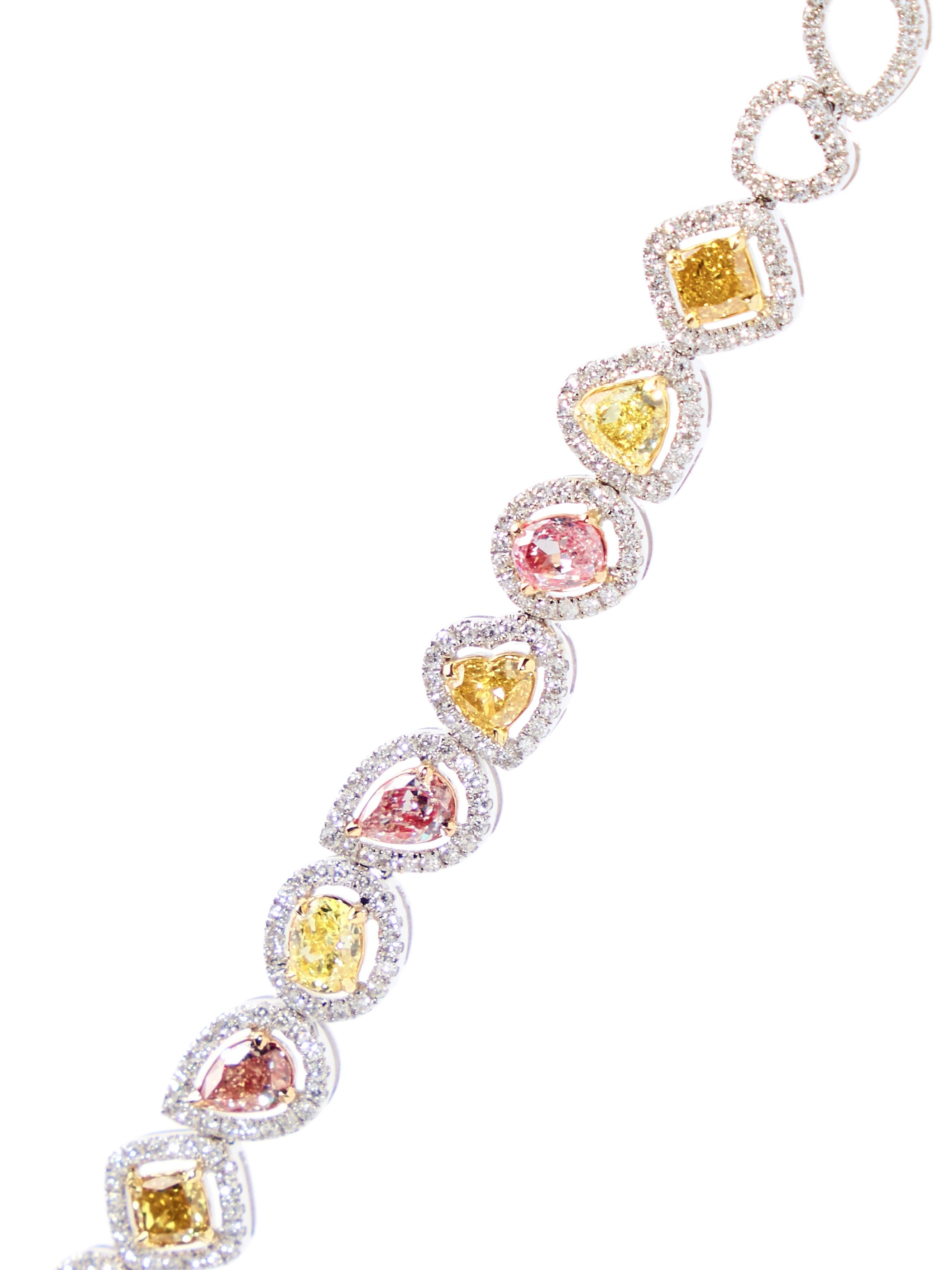 Fancy colored diamonds in a myriad of shapes grace this extraordinary bracelet. 

The bracelet is made in 18kt white gold and is set with 12 mixed fancy color cut diamonds weighing 1.98 carat and 1.26ct round brilliant cut diamonds. The 15 openwork
