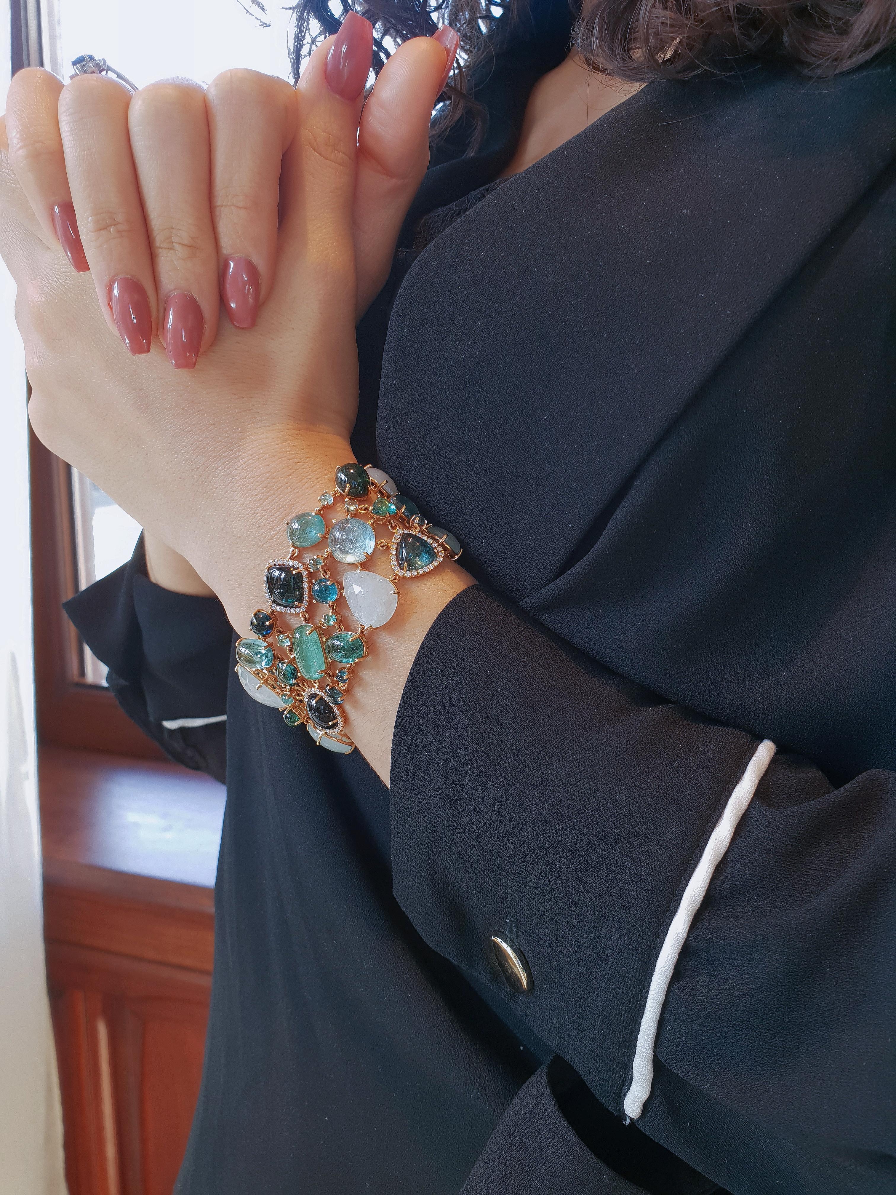 Meet your new colour crush. This bold and breathtaking 35 mm wide bracelet boats 50 multi-shaped blue greenish tourmalines, indigolite and milky aqumarine, a total of 32.16 carat gems and 1.36ct diamonds in a Top Wesseltion VVS-VS quality.

The