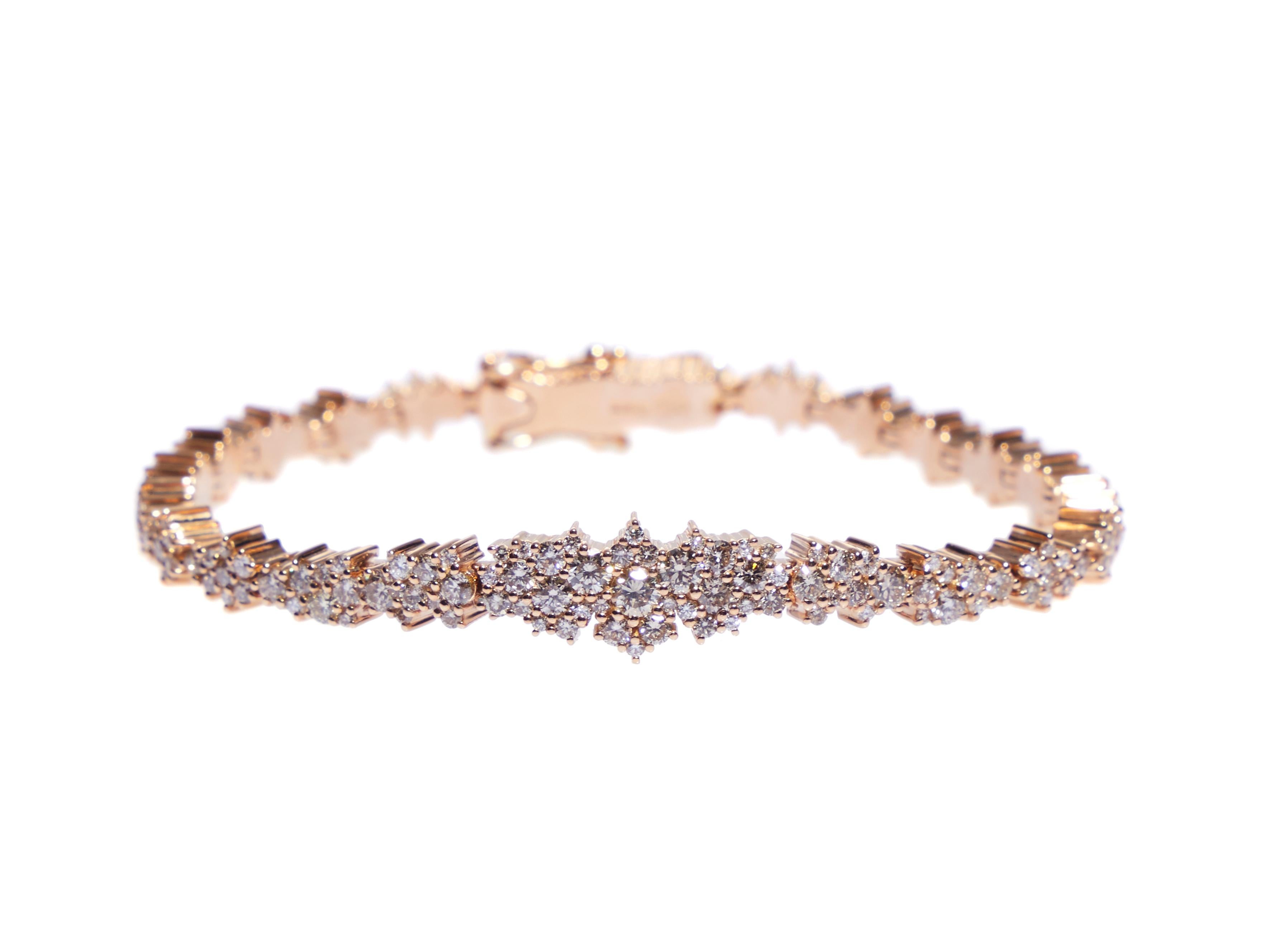 This 18 karat rose gold bracelet features round brilliant cut white diamonds, round cut brown diamonds in a unique prong setting. A modern take on a classic diamond 
tennis bracelet. 

The total diamond weight is 4.06 carats, 3.40 carat brown