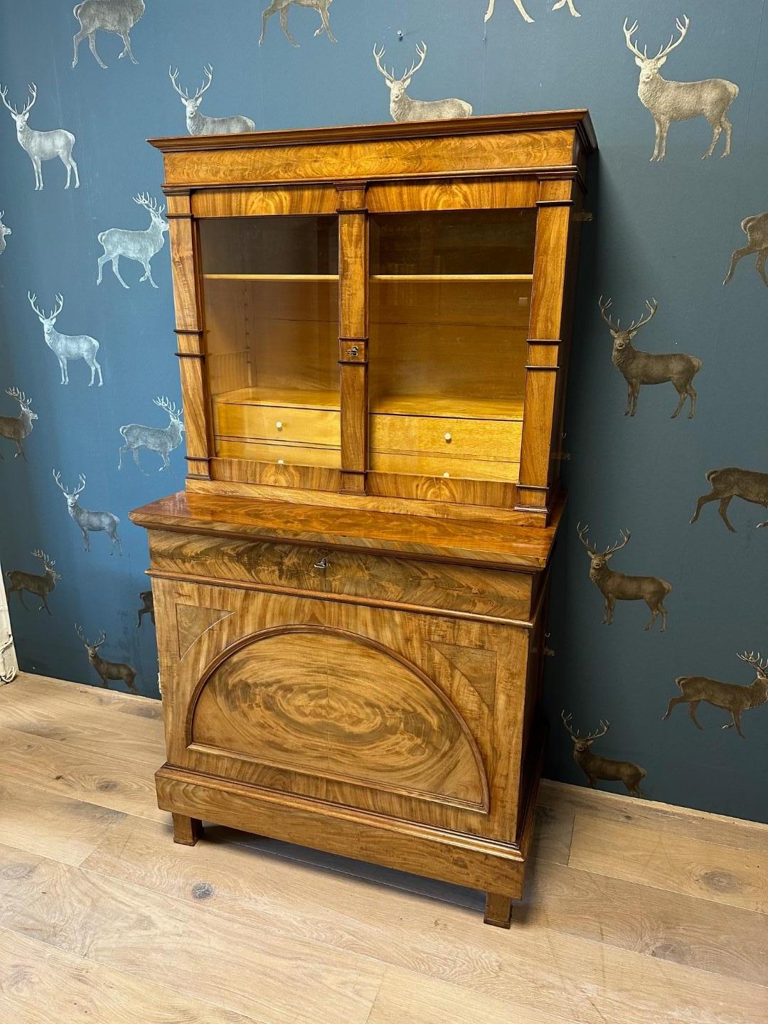 Bonheur du jour or ladies' desk in mahogany with floral mahogany and satinwood. Beautiful warm lived-in color. The base cabinet with a large door containing an arched panel and a wide drawer containing a red with gold-edged writing surface. The