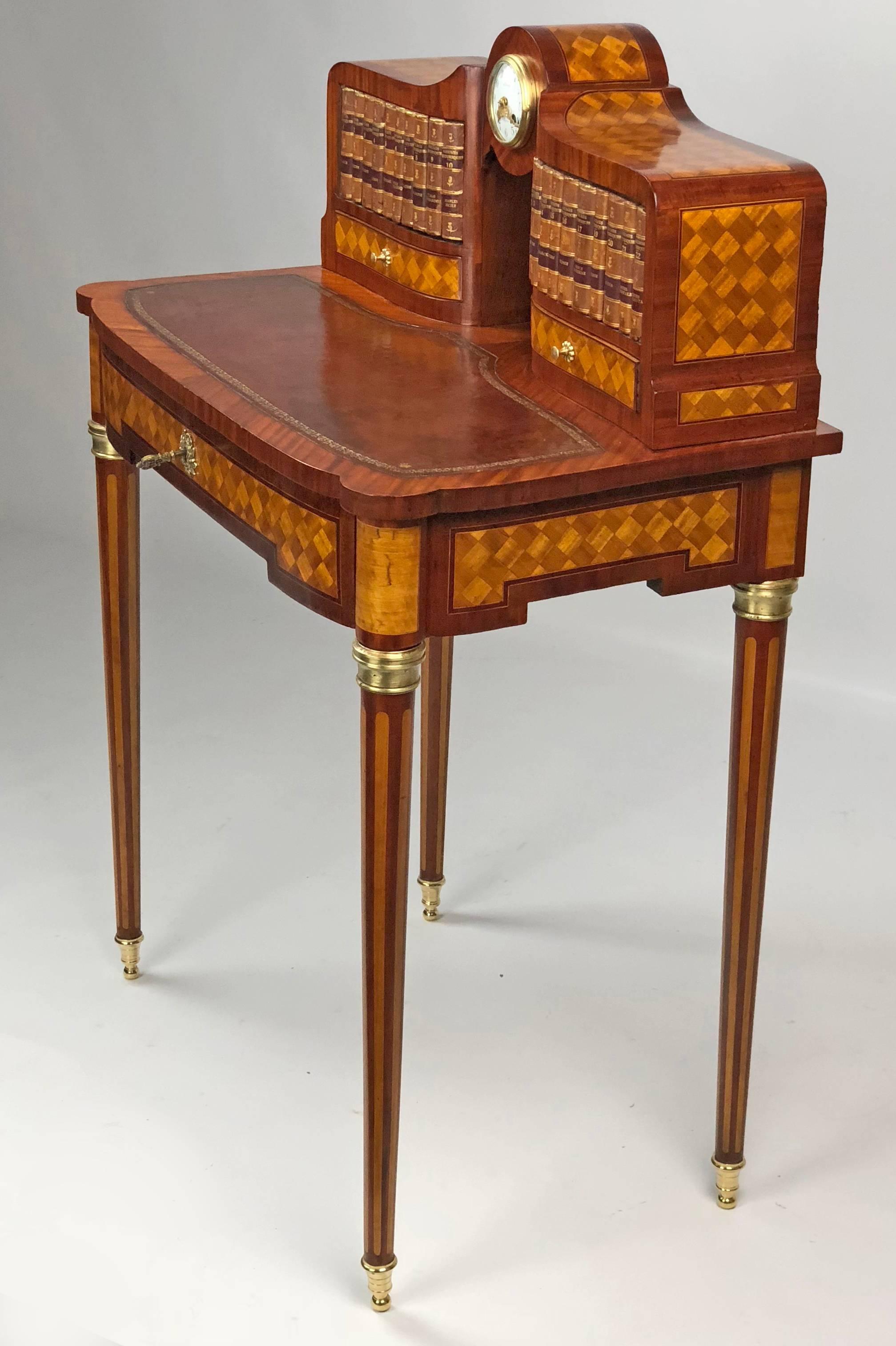 A jewel of a 19th century French Bonheur du Jour aka ladies' desk in mahogany, rosewood, kingwood and profuse parquetry inlay of satinwood.  Bow front and serpentine sides, it has a superstructure with 2 faux book doors that only open via hidden