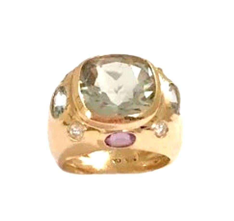 The Christina Addison Bespoke BONHEUR Ring: 18kt Yellow Gold Domed Ring with faceted 15mm Cushion Cut Green Amethyst center stone and faceted oval Purple Amethyst stones and round Blue Topaz stones. A chic cigar band or gypsy style ring with a bold