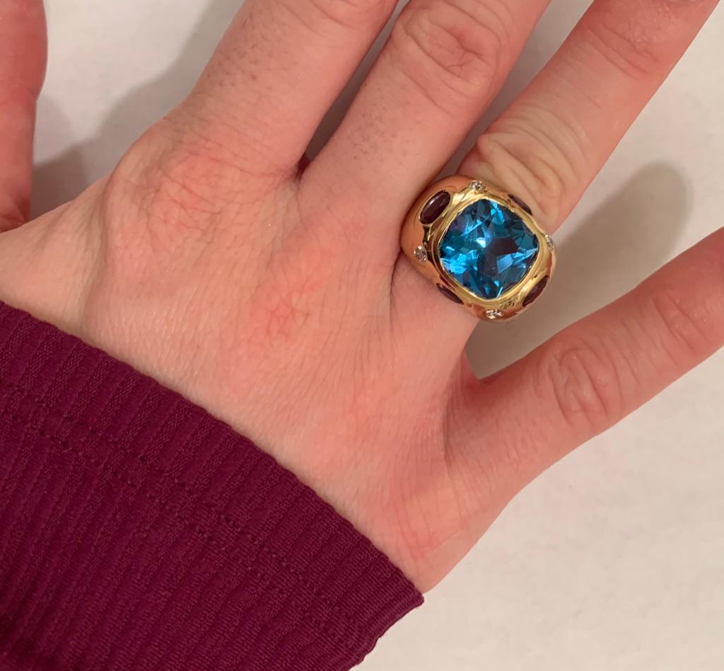 The BONHEUR Ring: 18kt Yellow Gold Domed Ring with faceted  Cushion cut center stone Blue Topaz Center stone and four faceted oval Amethyst  Topaz and round Diamonds. 

This ring is available in in any color stone combination.  For example:  A