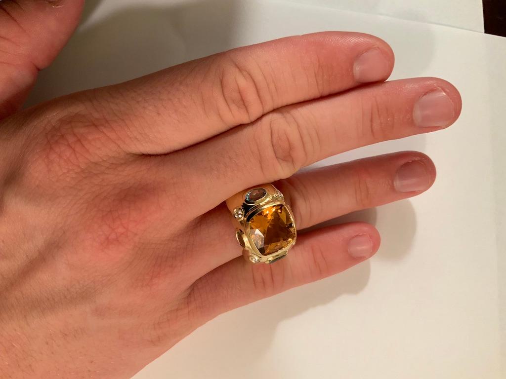 The BONHEUR Ring: 18kt Yellow Gold Domed Ring with faceted Citrine, Cushion cut center stone and two faceted oval Peridot and two faceted oval Pale Blue Topaz and round Diamonds. 

This ring is available in in any color stone combination.  For