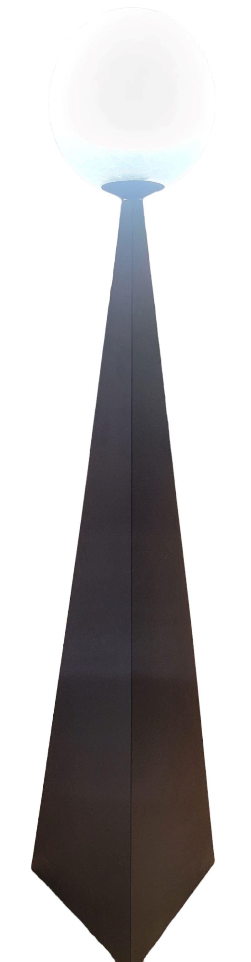 Bonhomme Floor Lamp By Artlier Areti. Wonderful Black Body with a triangular base that widens as it goes down for a more stable base. The Bulbe is a textured glass. With many intersecting waves. Wonderful look and modern setting. Measures approx -