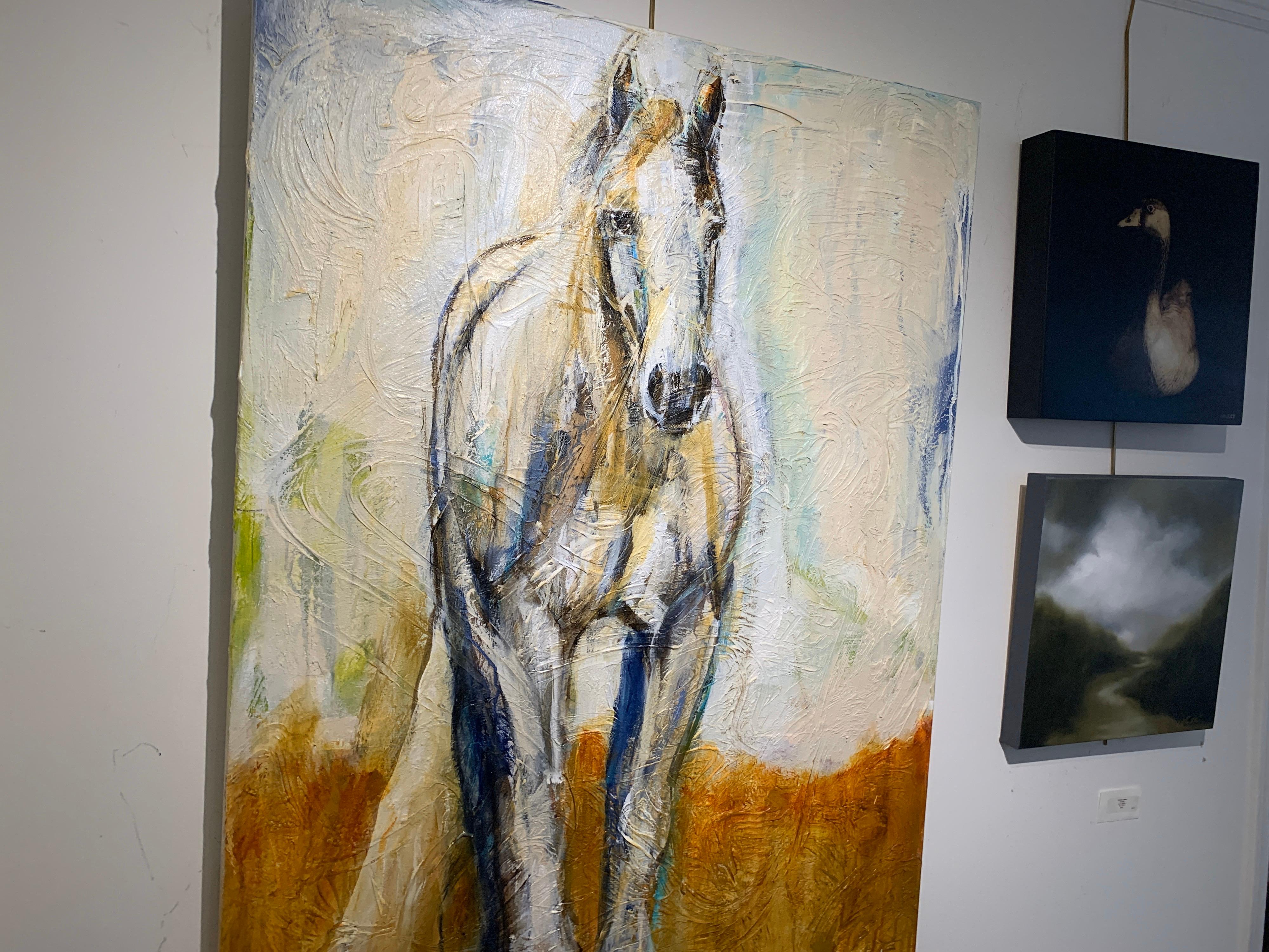 'Elle' is a large mixed media on canvas horse painting created by American artist Bonnie Beauchamp-Cooke in 2020. Featuring an elegant white horse who seems to be walking calming towards us while looking straight ahead, the piece is painted in a