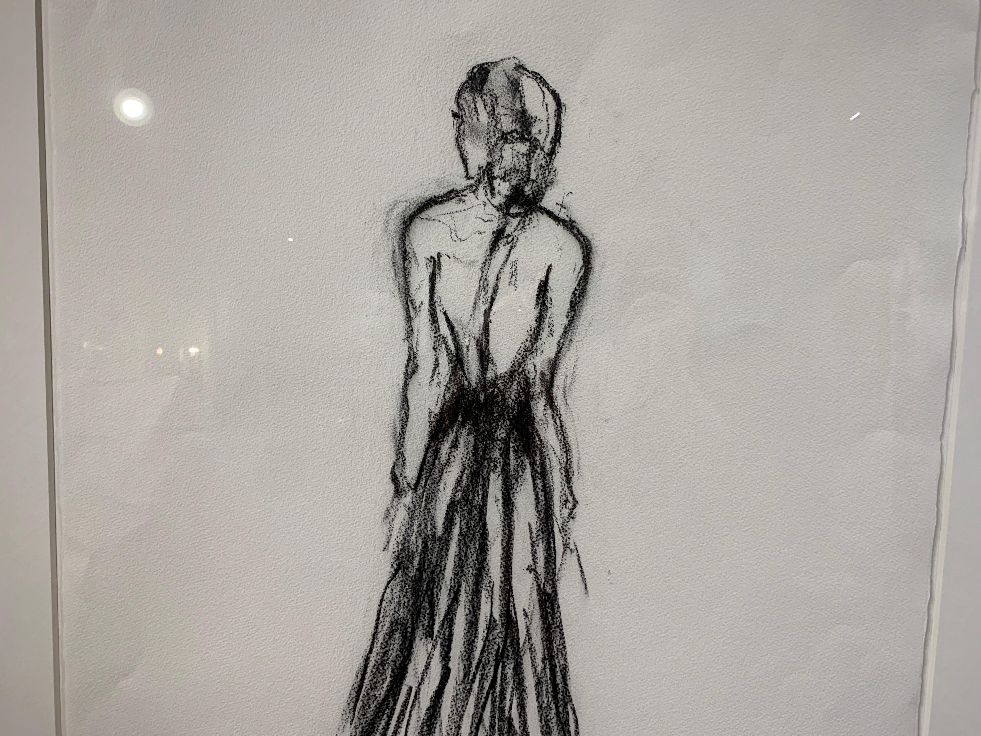 'Lady in Charcoal II' is a vertical framed Impressionist charcoal on paper black and white drawing created by American artist Bonnie Beauchamp-Cooke in 2019. Featuring a sketch in charcoal, the painting depicts an elegant lady wearing a mesmerizing
