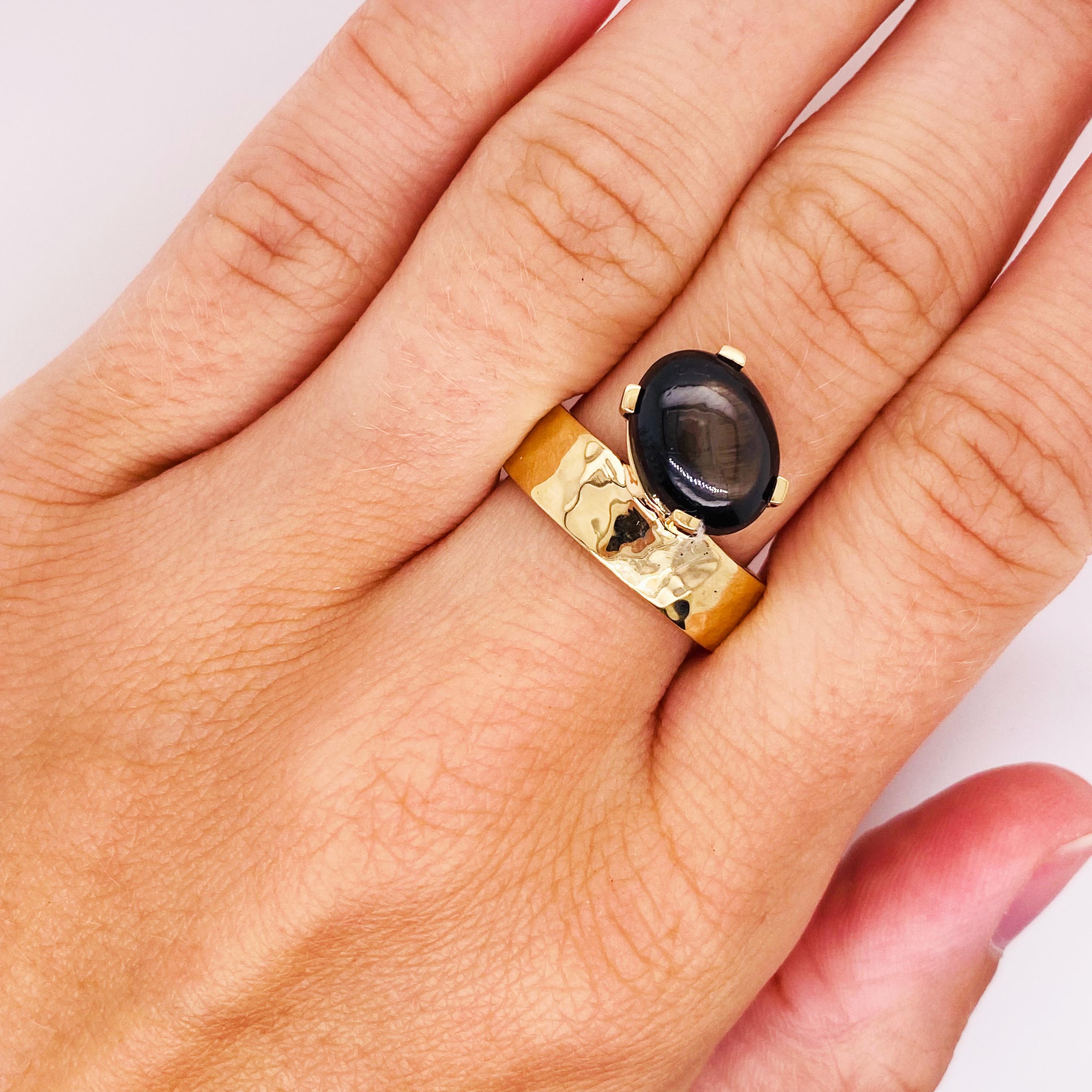 The Bonnie is a genuine black star sapphire that is set on a 14 karat yellow gold band that is a one-of-a-kind ring. The Bonnie has a black star that will roll around in certain light. The gemstone weighs 3.65 carats and is a gorgeous specimen. The