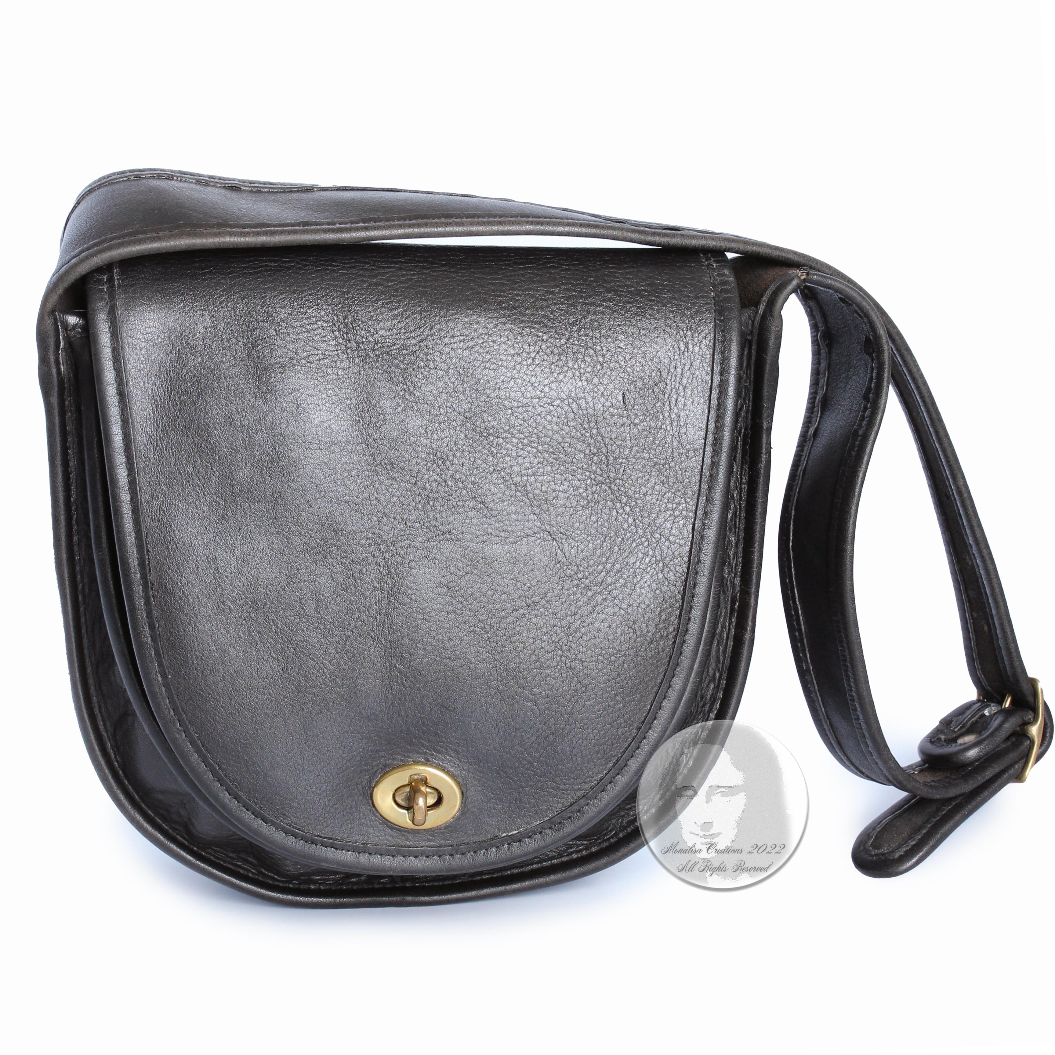 Authentic, preowned, early 70s Coach Cashin Era 'Kangaroo' Shoulder Bag Pouch with wide shoulder strap, likely made in the early 70s.  Made from black leather, it's unlined with a 'kangaroo' pocket under the flap and one interior pocket.  A chic