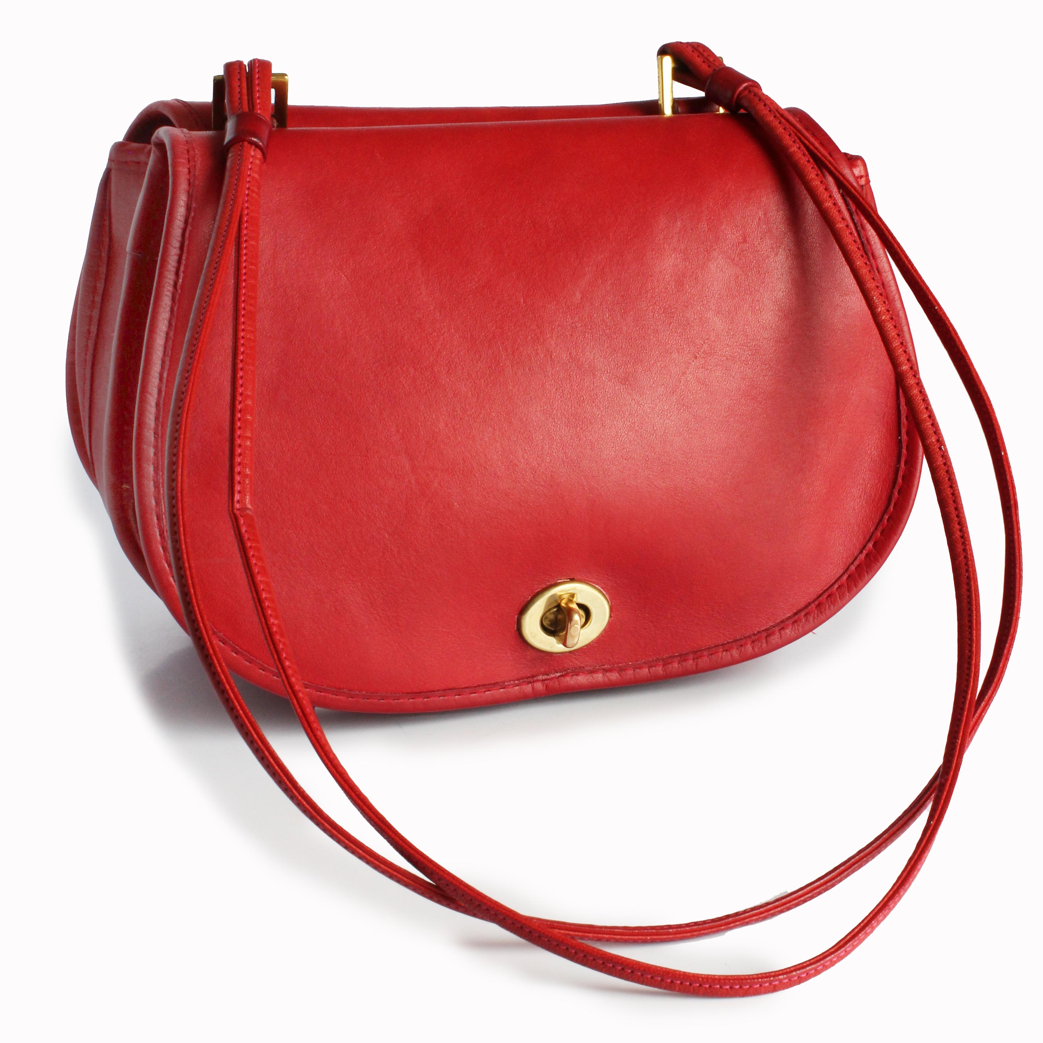 Preowned, vintage Bonnie Cashin for Coach '2-in-1 Pouch' shoulder bag, released between 1972-1973.  A unicorn, especially in this color!  Made from a wonderfully patina'd red leather, it features turn lock pouches on each side and a non-adjustable,